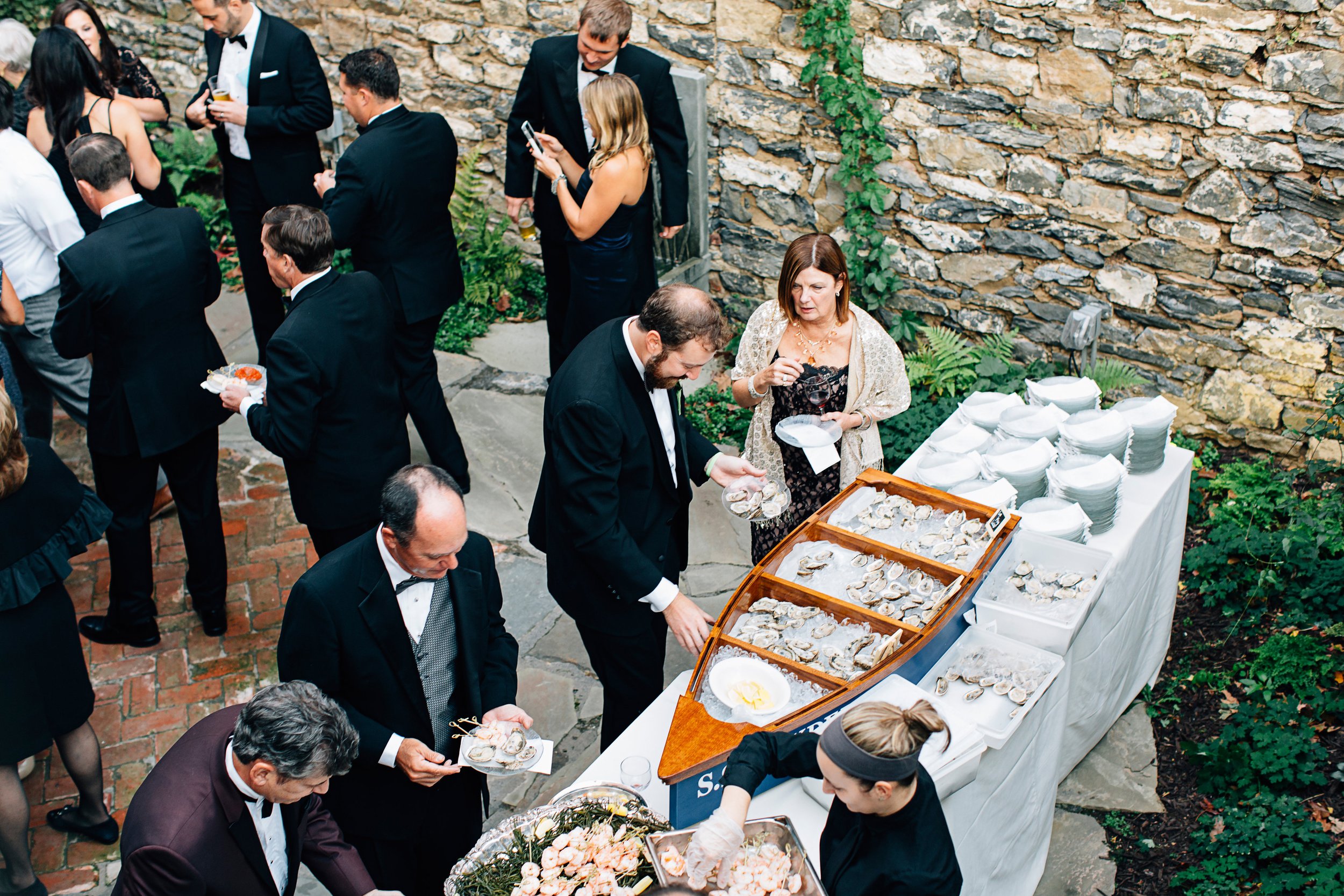 Outdoor oyster food station served in wooden boat