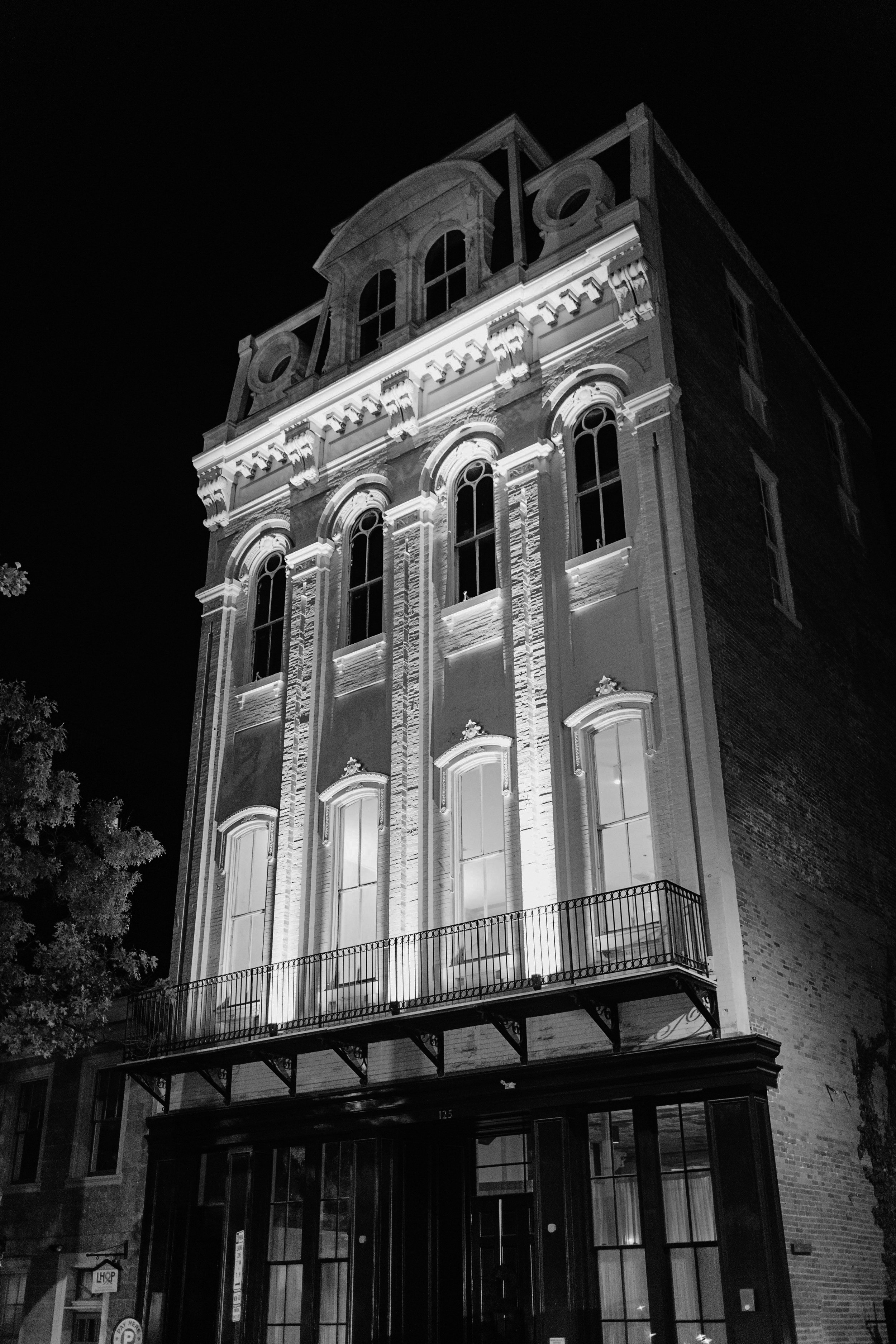 Black and white photo of Excelsior front facade lit up