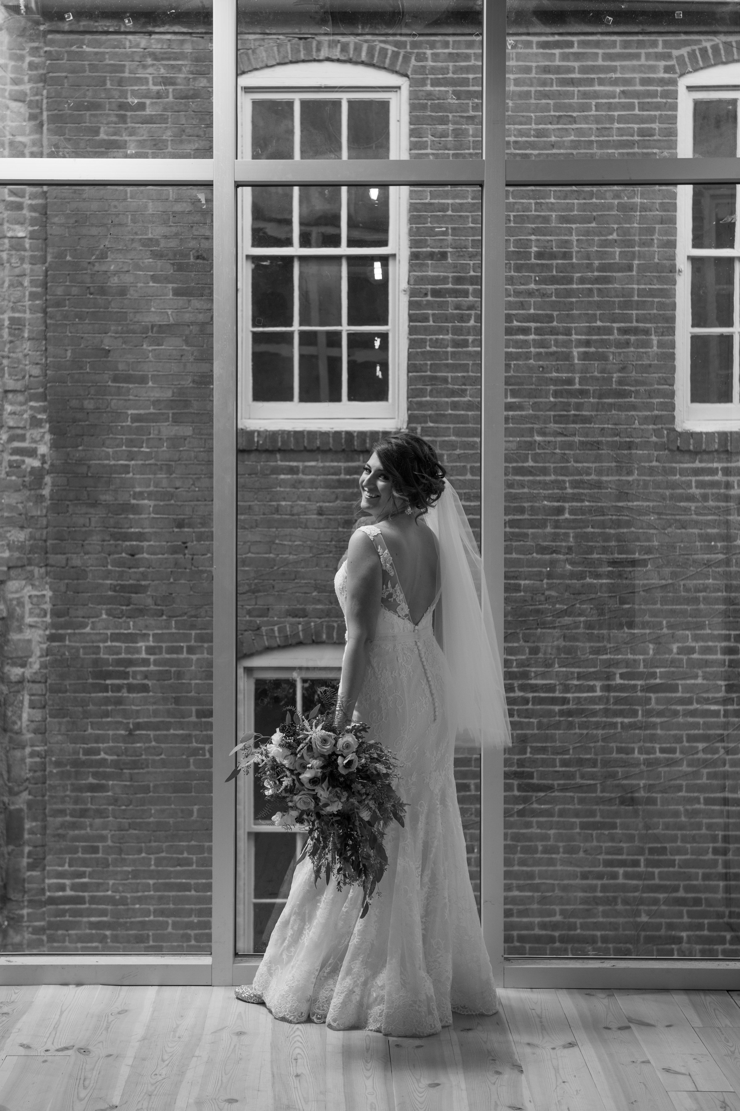 Bride in front of large window in black and white