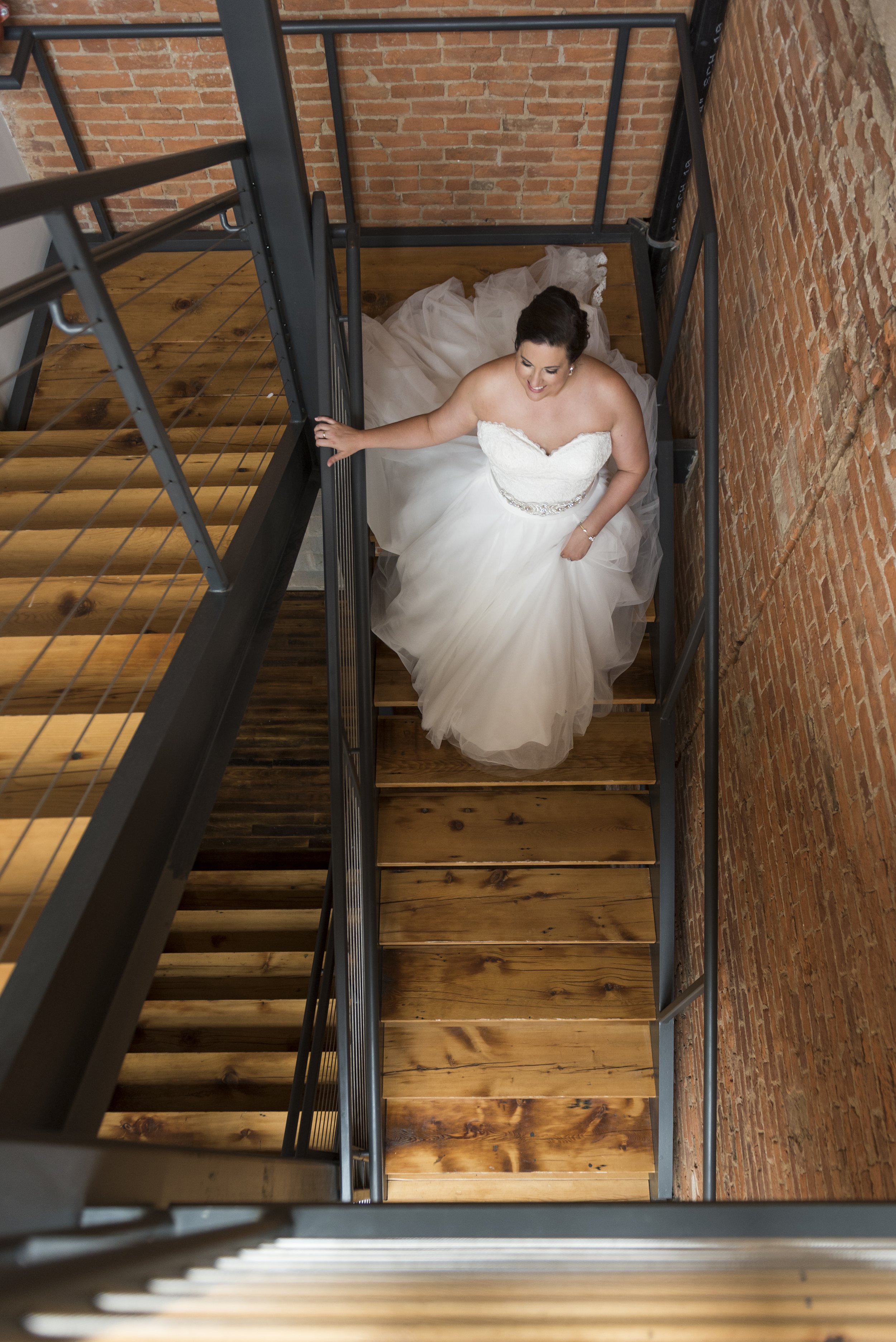 Bride walking down staircase from above