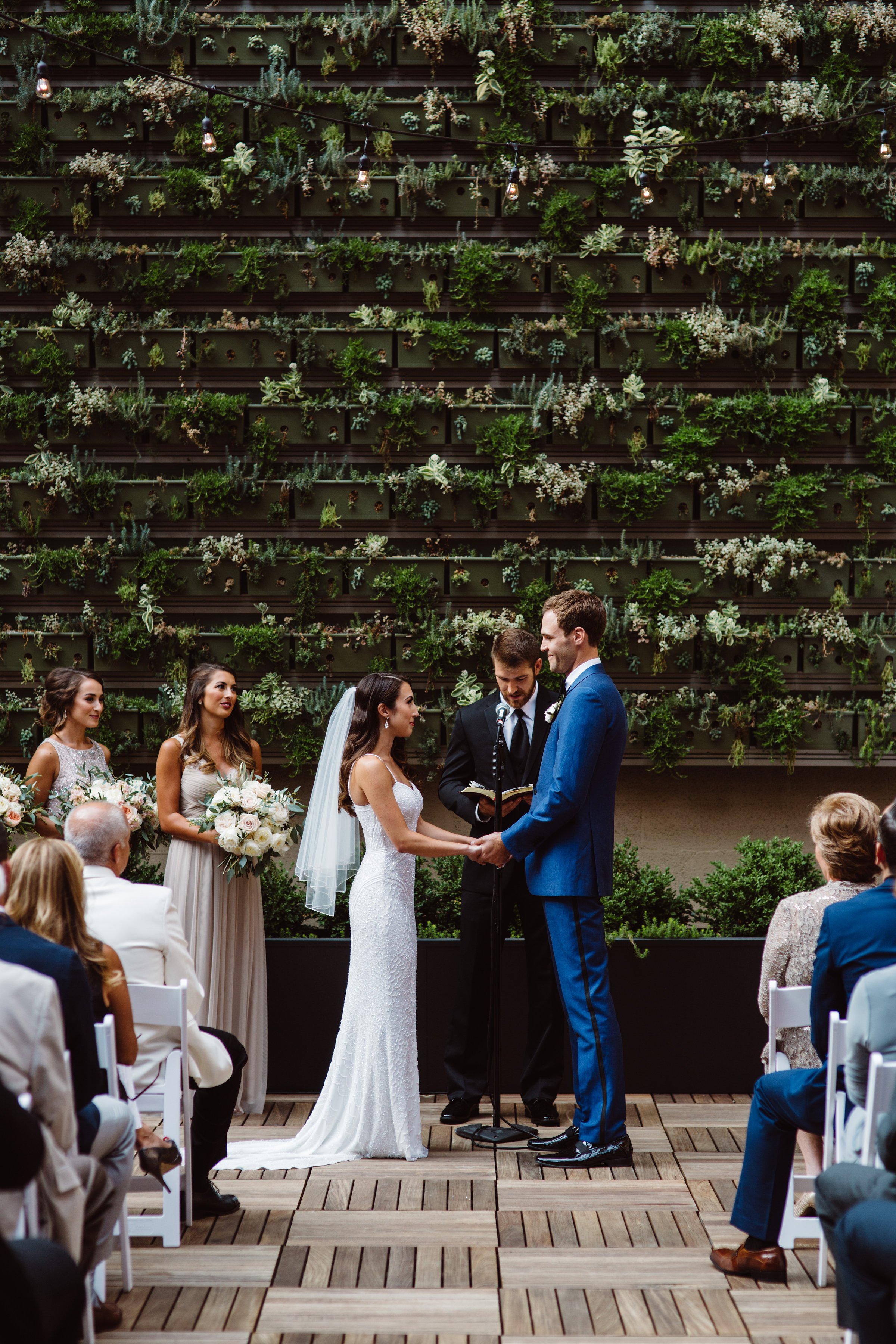 Ceremony on outdoor Terrace in front of greenery succulent wall