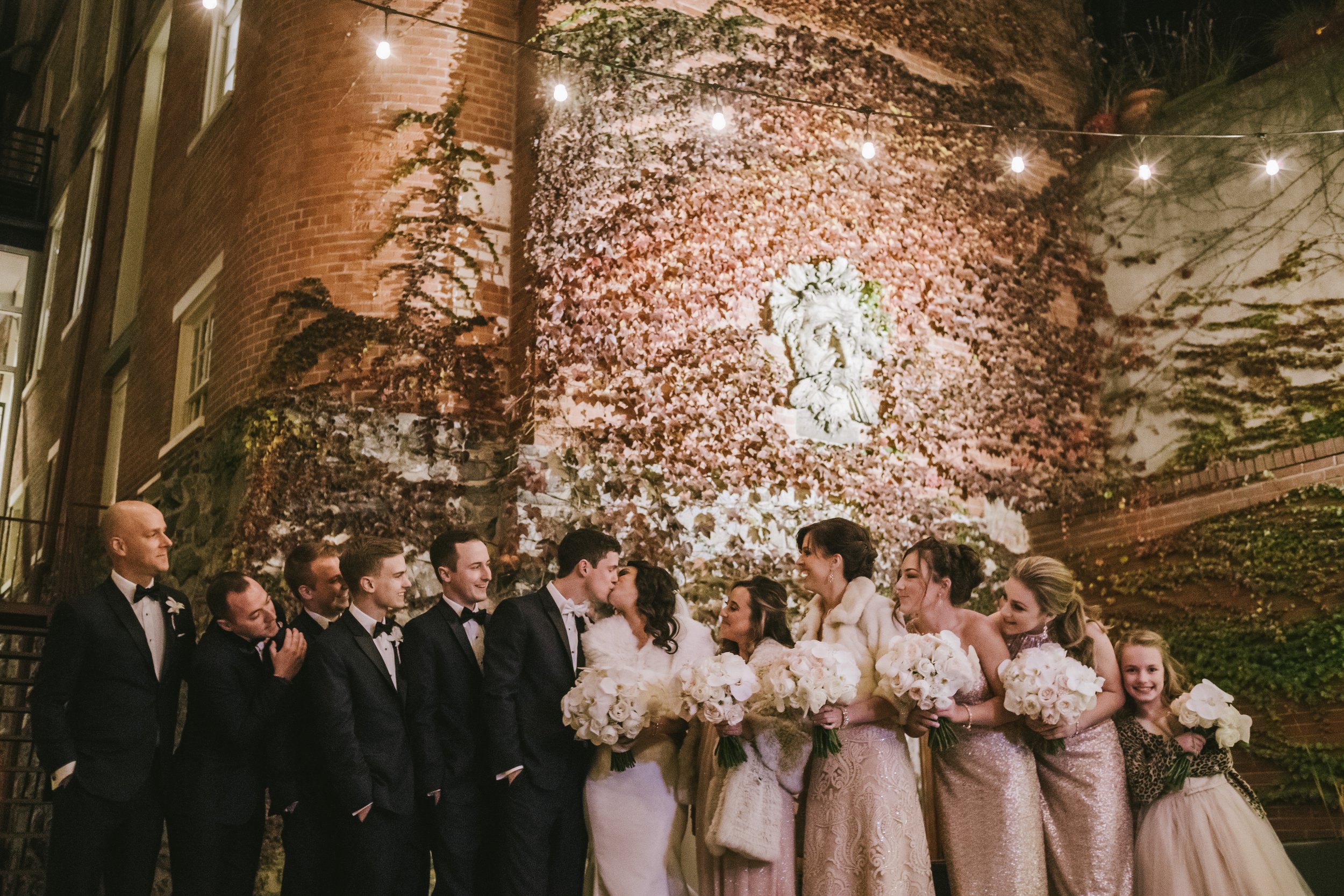 Bridal party outside under canopy lights