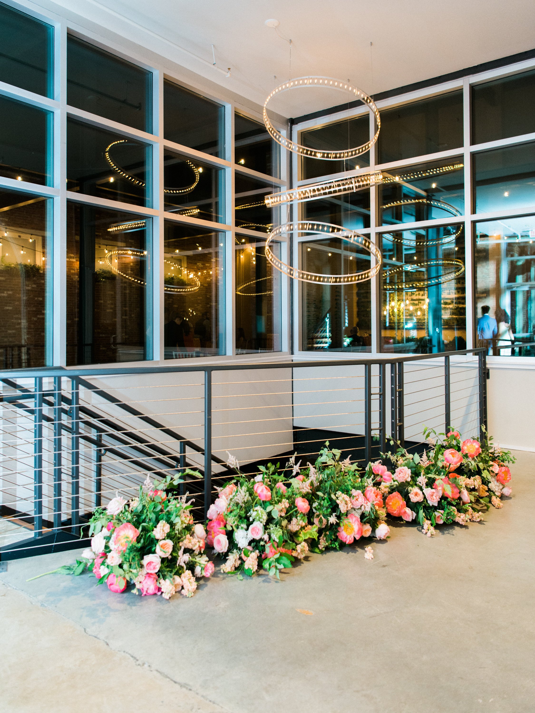 Large stacks of flowers by staircase in lobby of Excelsior