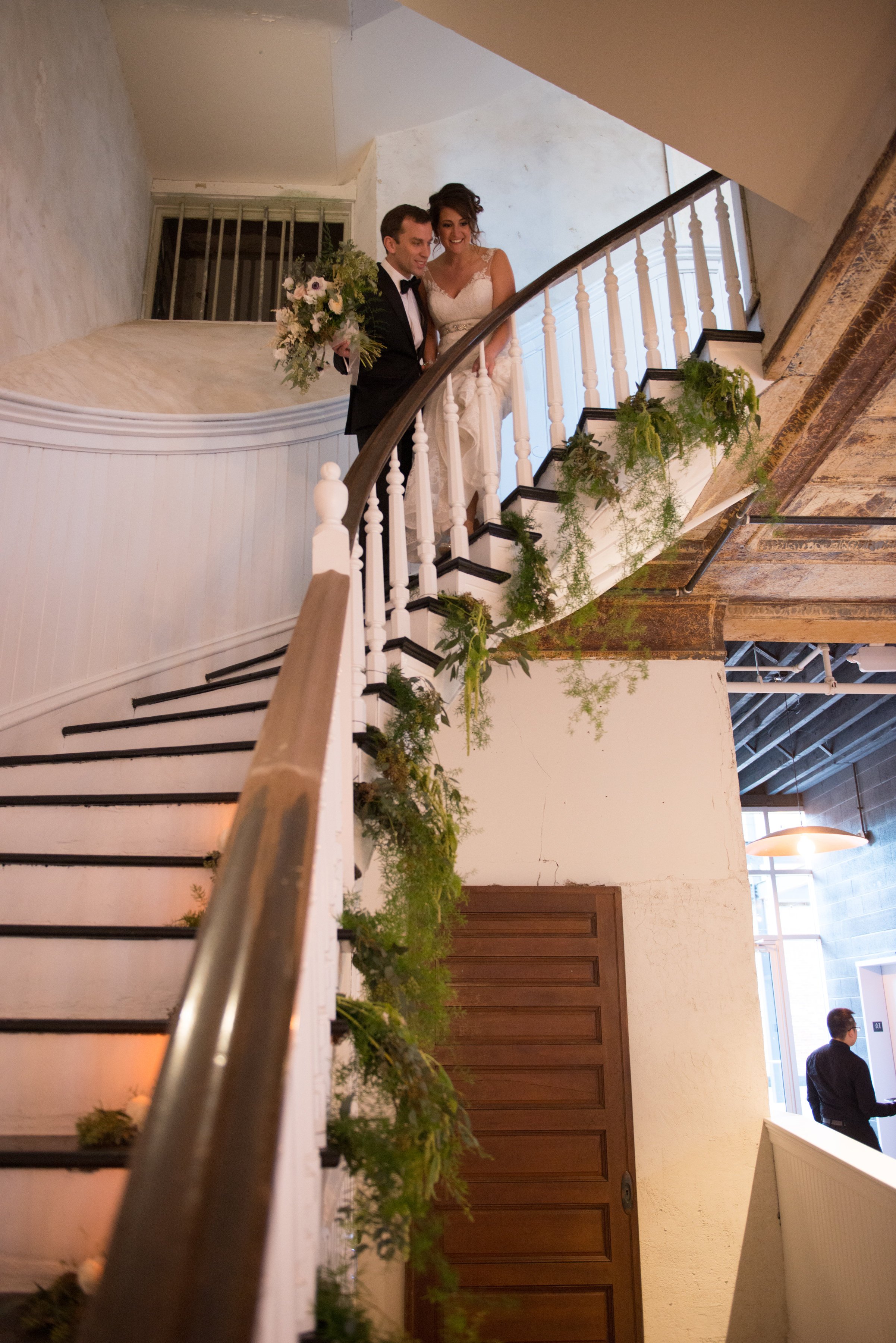 Couple posing at top of grand staircase in Grand Salon at Excelsior