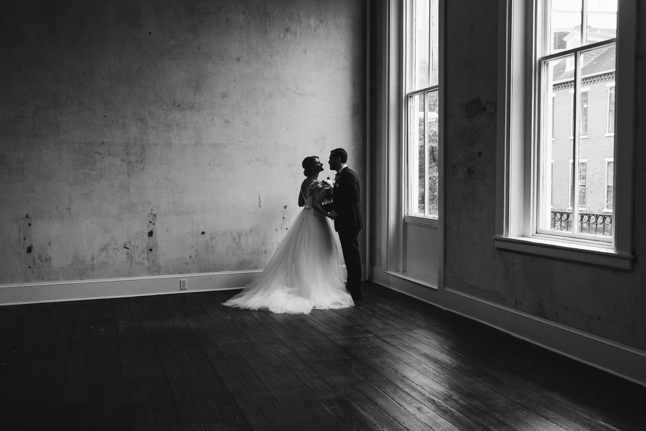 Bride and groom in dramatically lit large space