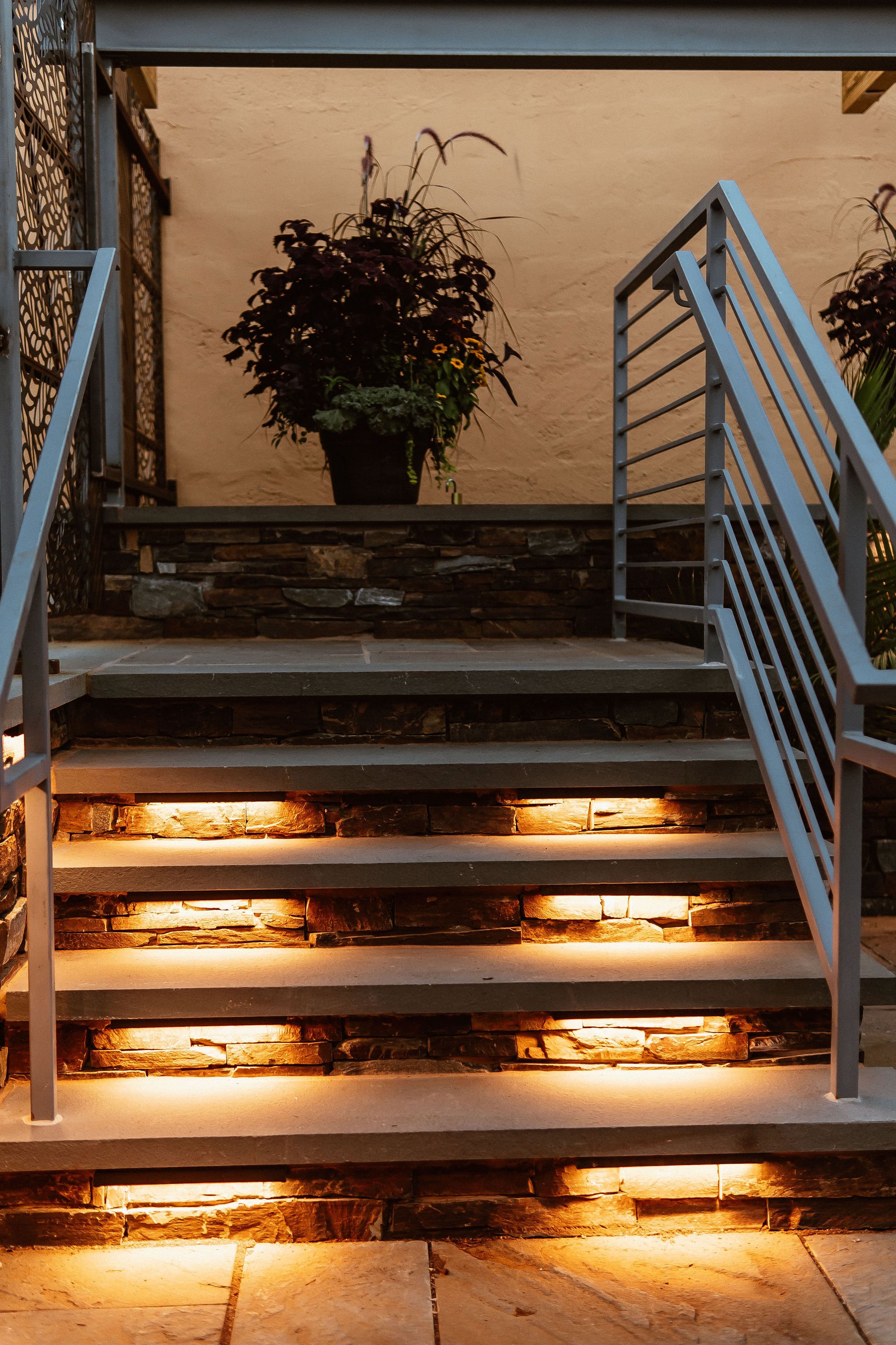 Outdoor staircase with golden lighted steps