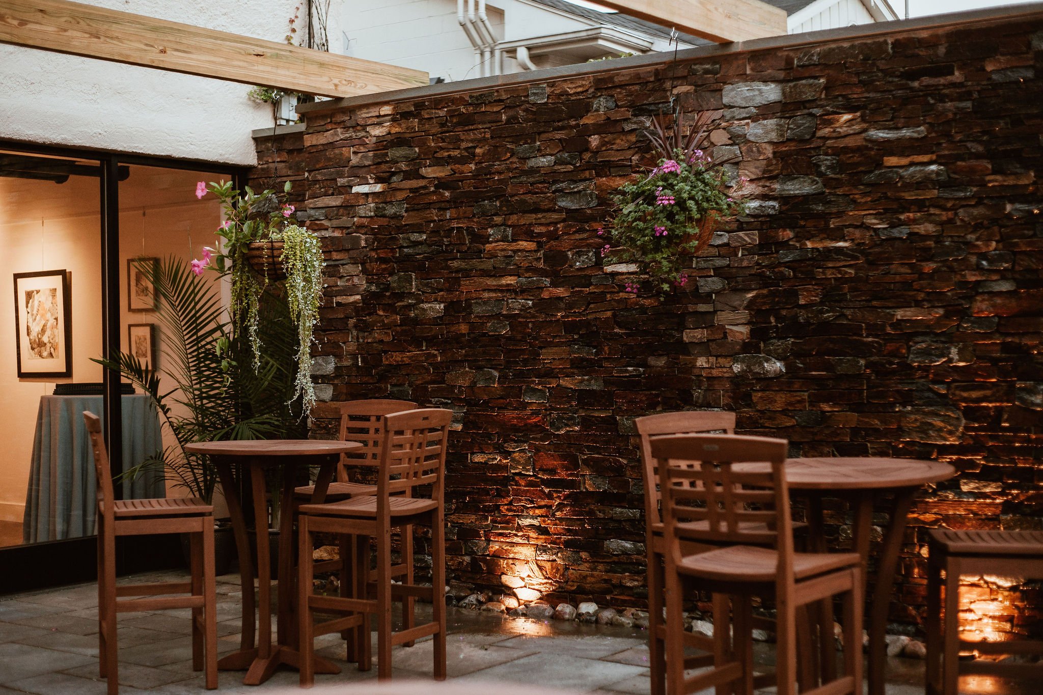 Outdoor patio area featuring cascading water wall