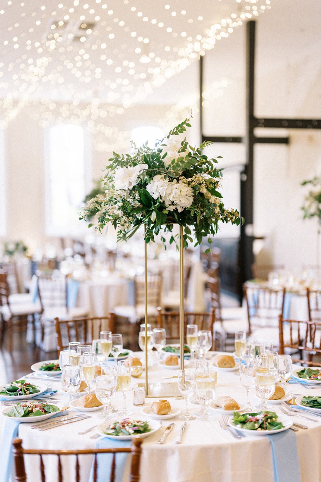 wedding reception table centerpiece white string lights greenery
