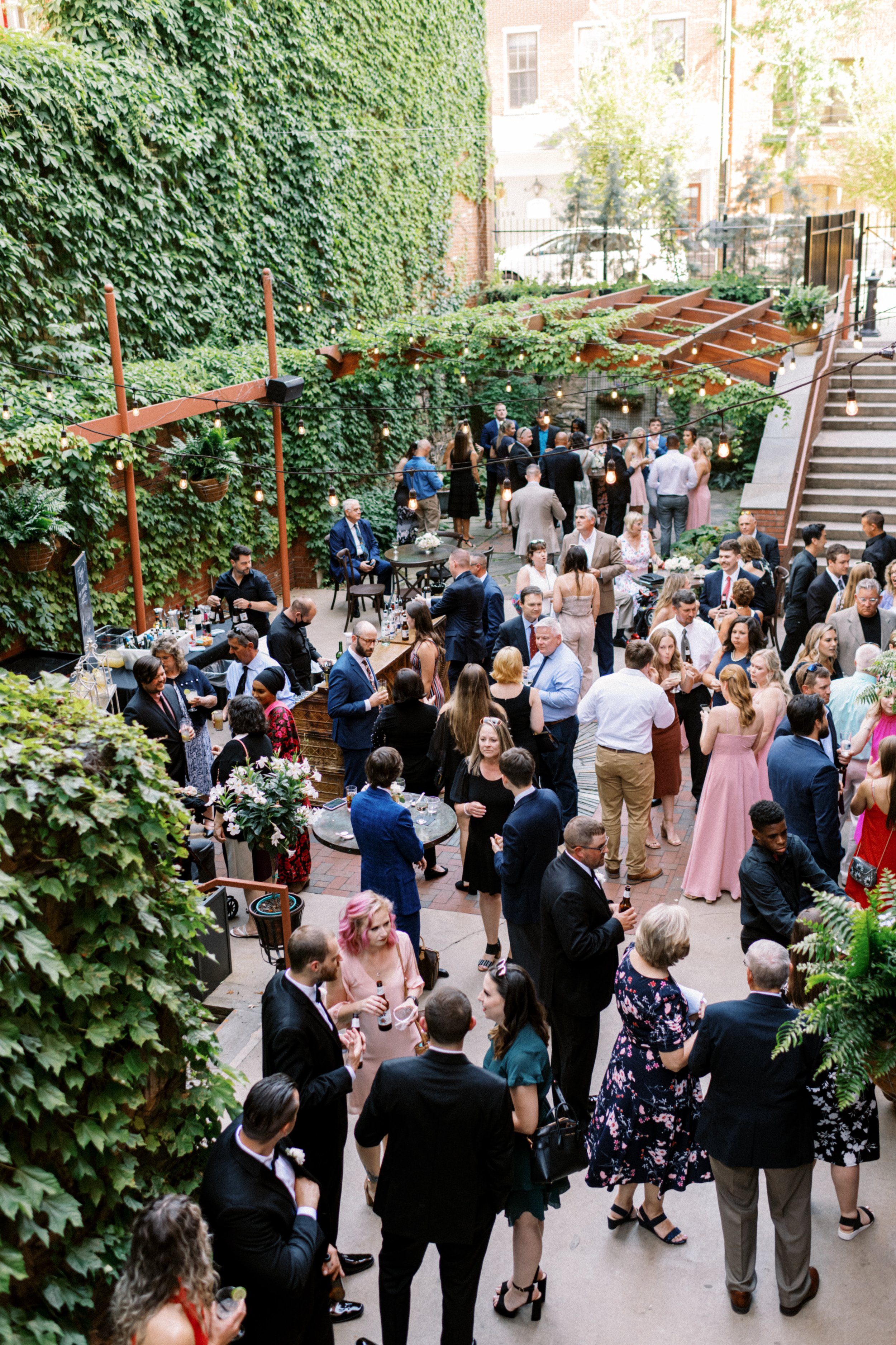 Event reception outdoors surrounded by greenery plants downtown