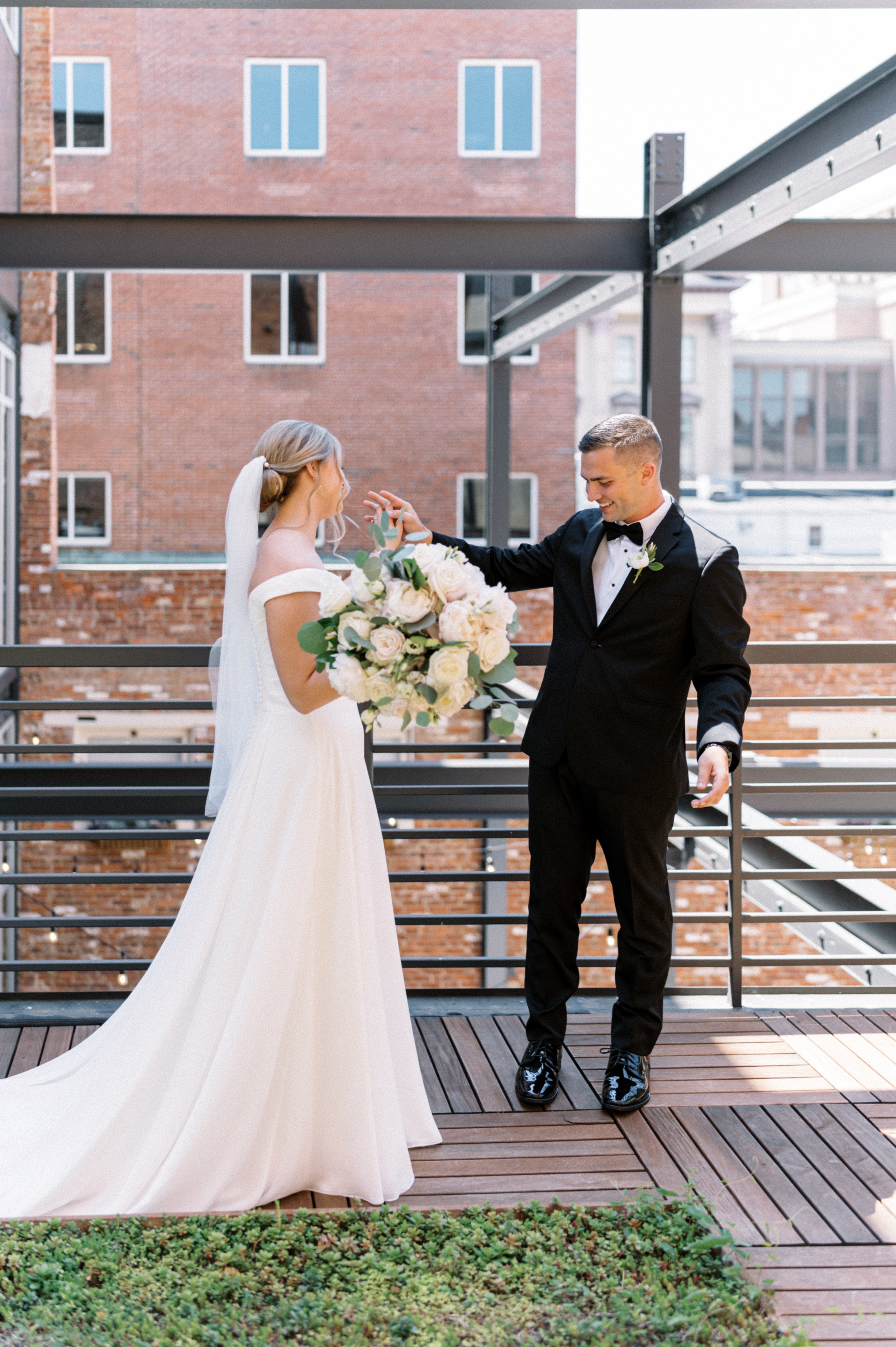 Bride and groom on rooftop deck patio overlooking Terrace