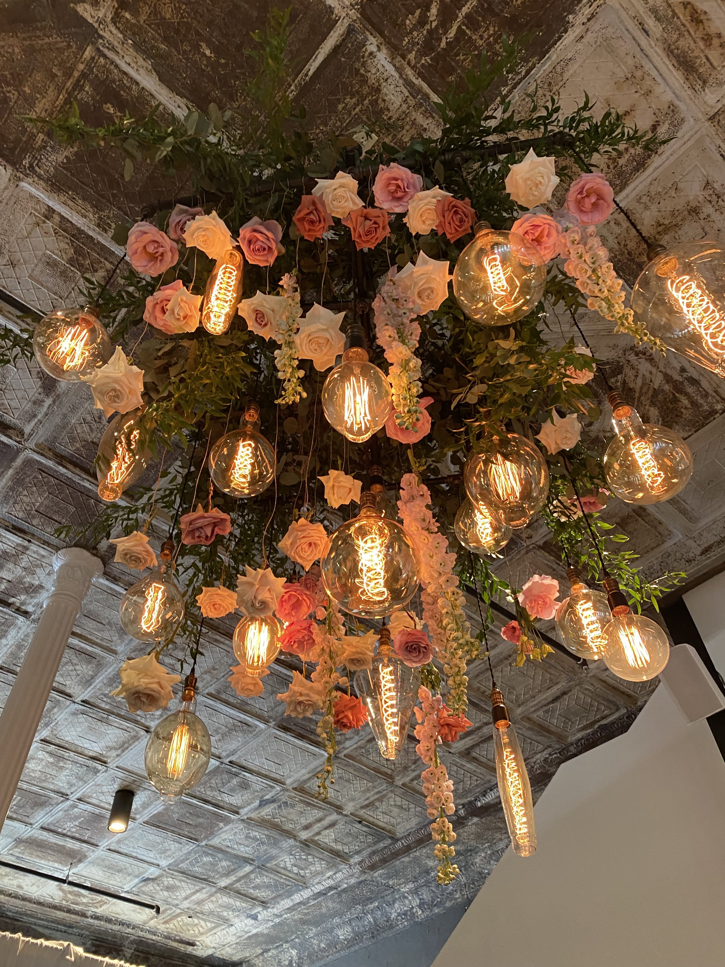 Ceiling light decor with edison bulbs and pink roses