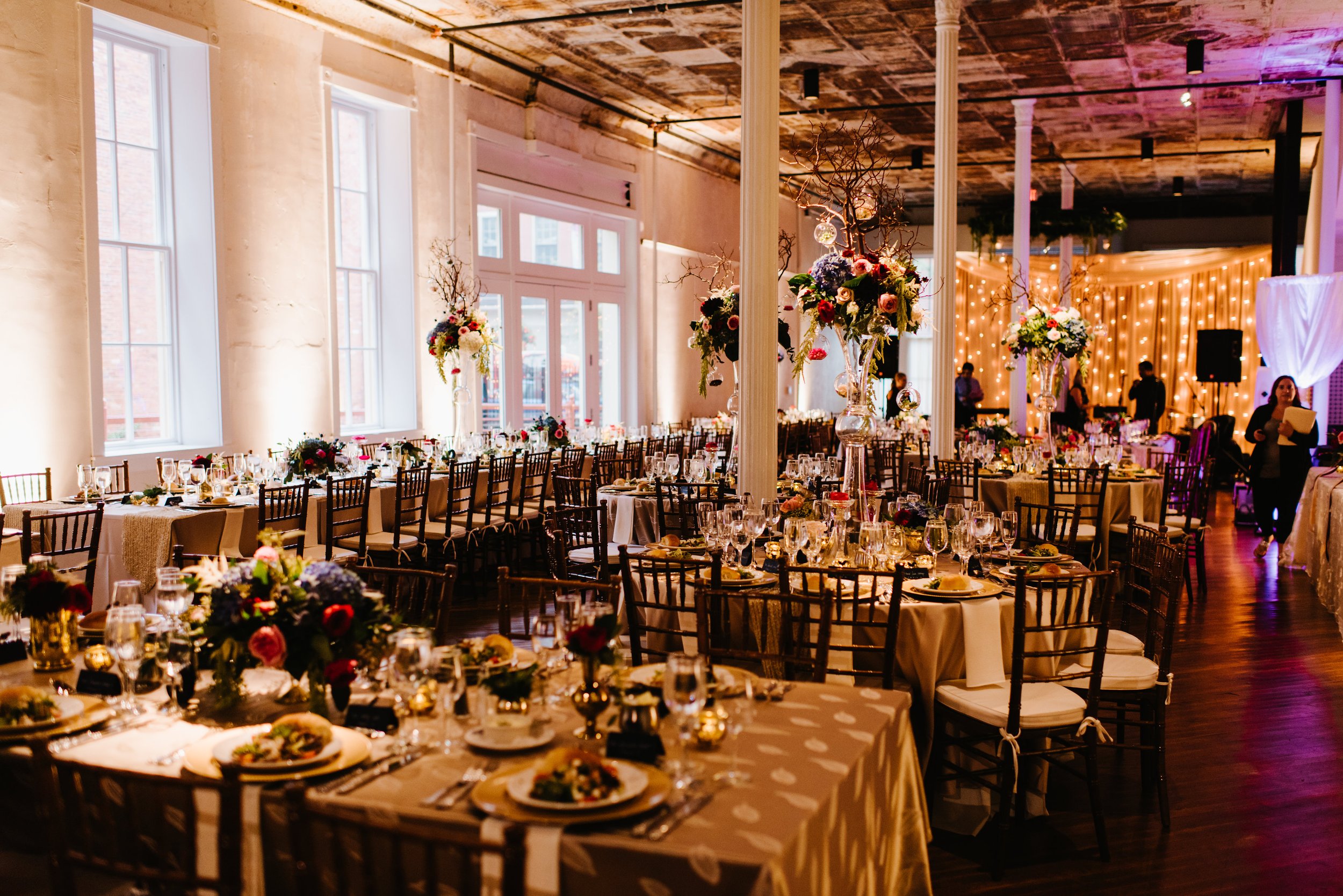 Wedding reception dinner tables with up lighting moody vibe