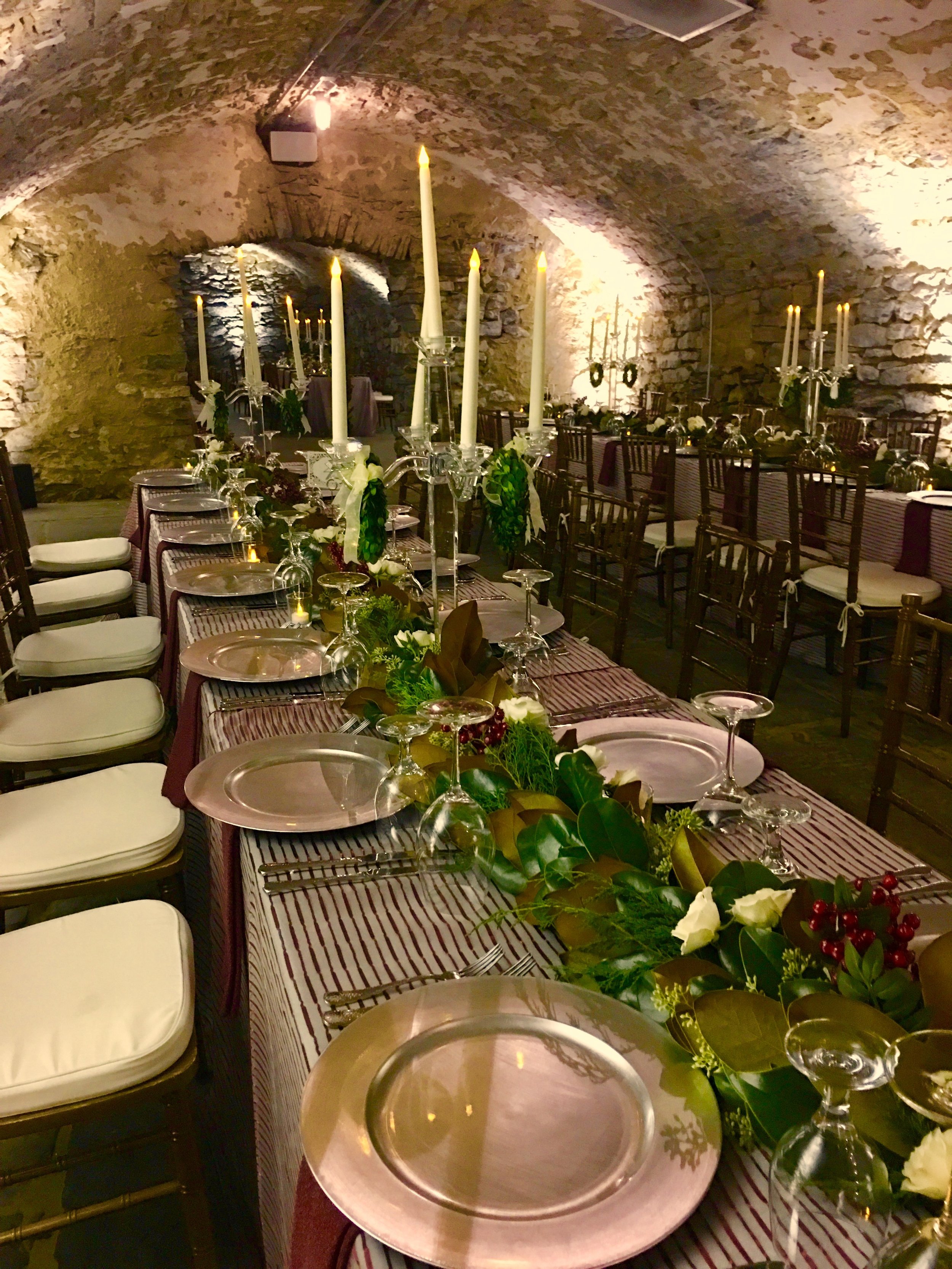 Long dinner table set up in catacombs