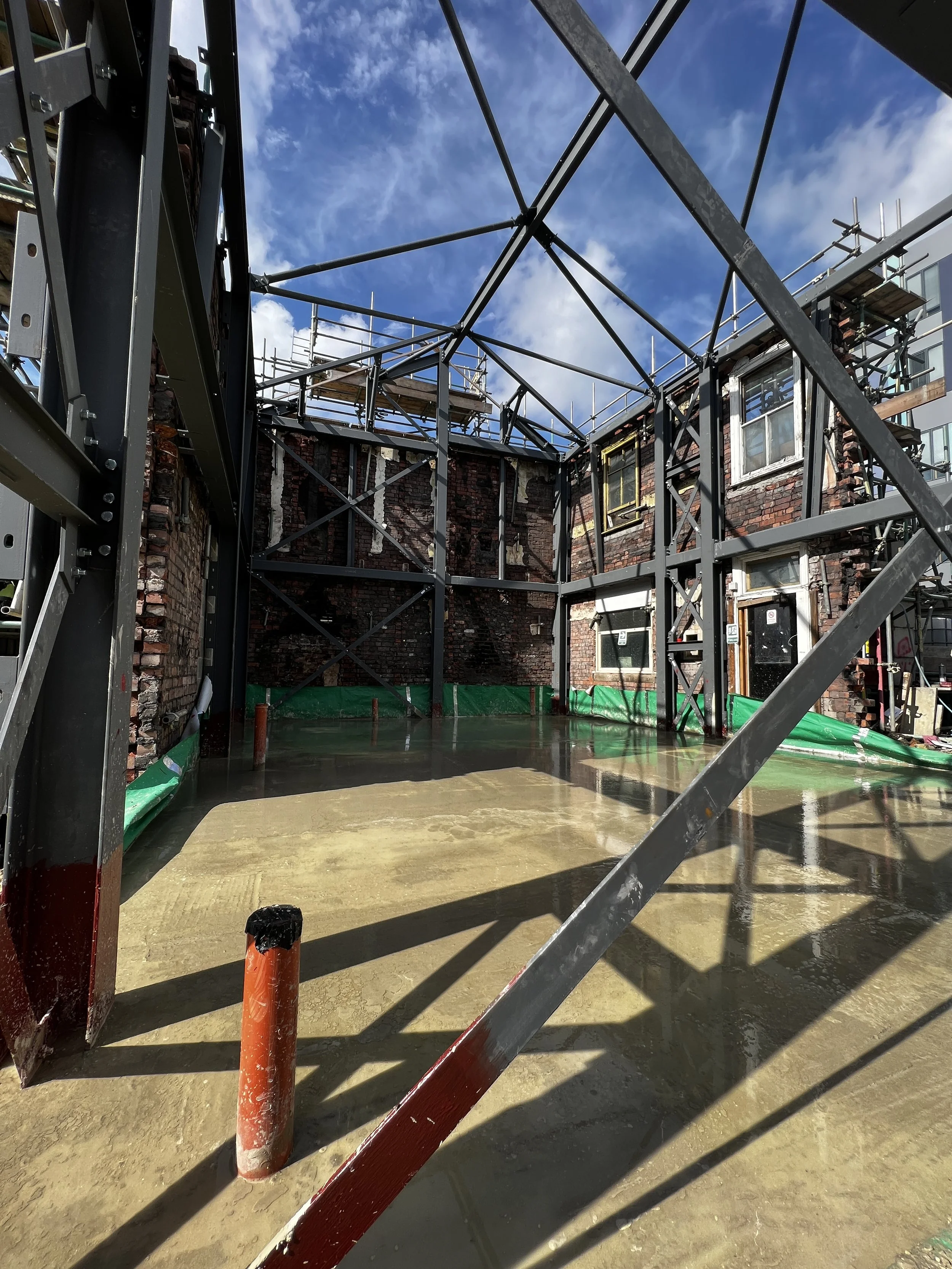 The steel frame &amp; ground floor slab before walls were re-built