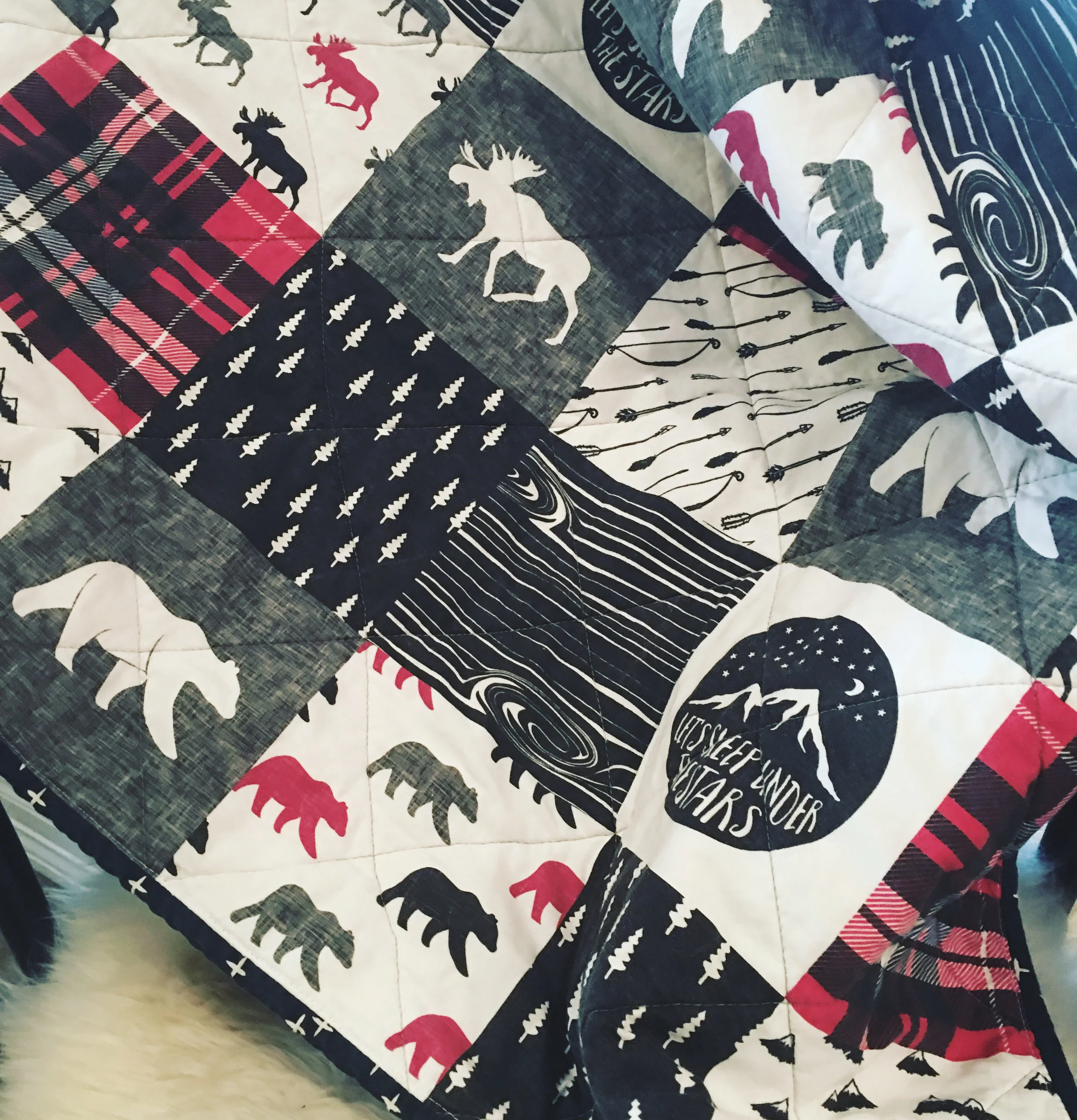 Quilt handmade by SewRebus using the Happy Camper Wholecloth design.