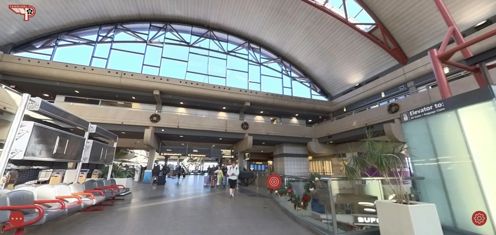 Pittsburgh’s former airport terminal in an interactive 360 tour, with an arched glass ceiling and red beams.