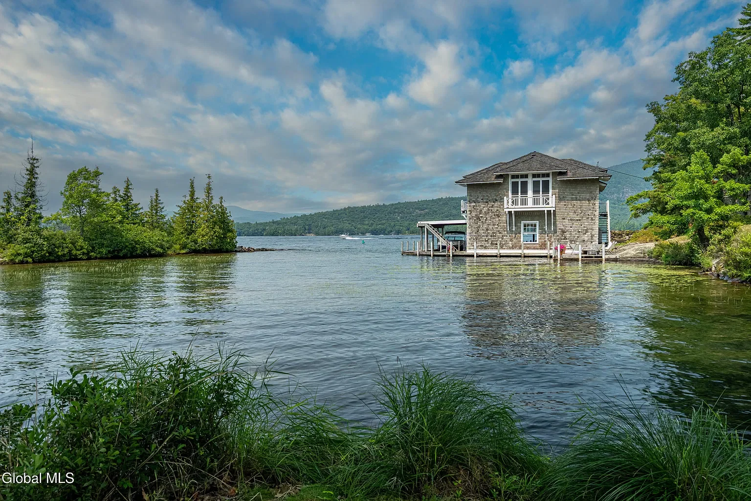 a 1905 cottage on a private island in the Adirondacks with a boathouse2.webp