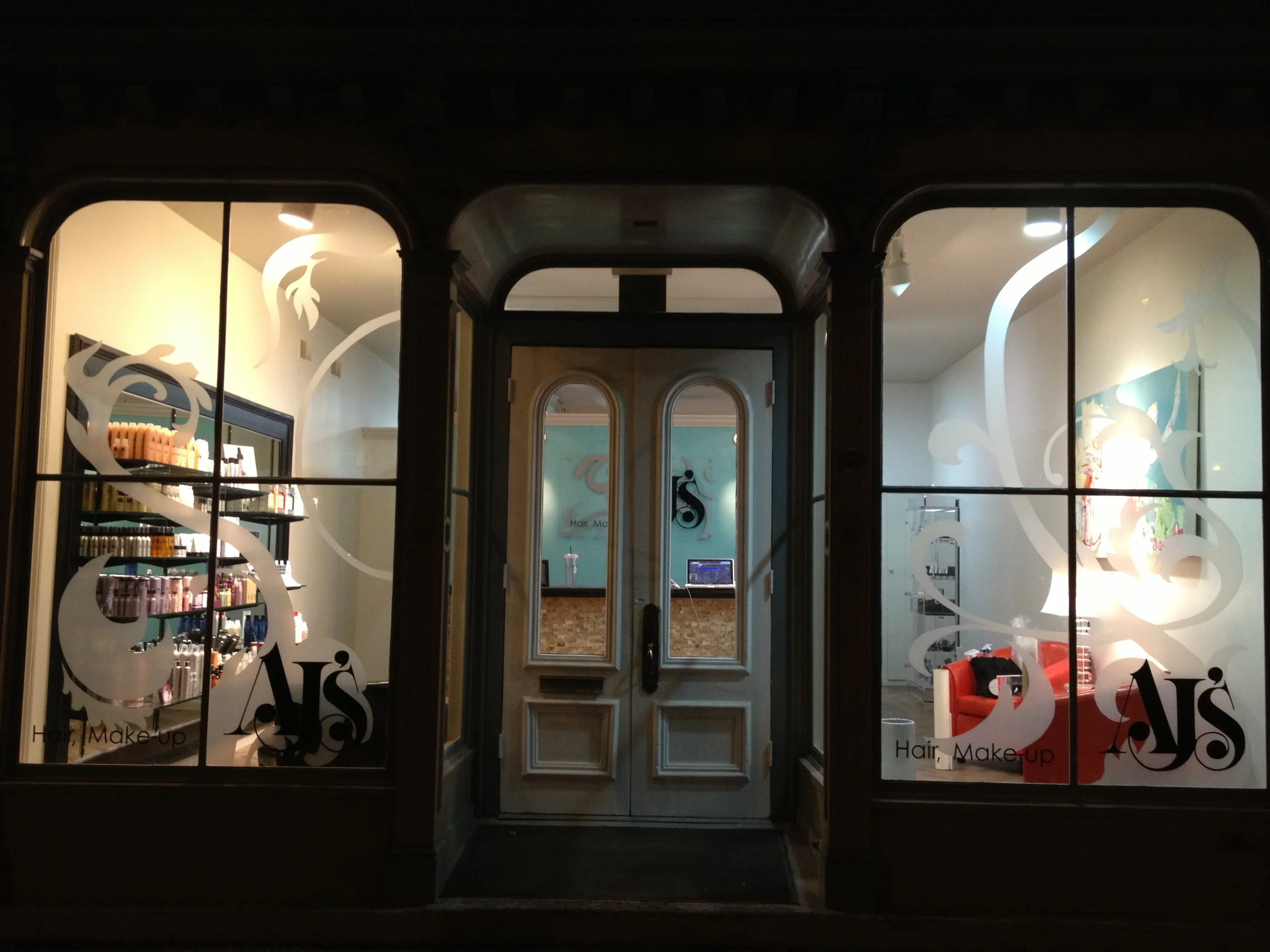  This local salon wanted the fleur de lis design from their business card recreated to take up the entire window in a frosted vinyl, providing a bit of an artistic touch and privacy without fully obstructing the windows and light.  