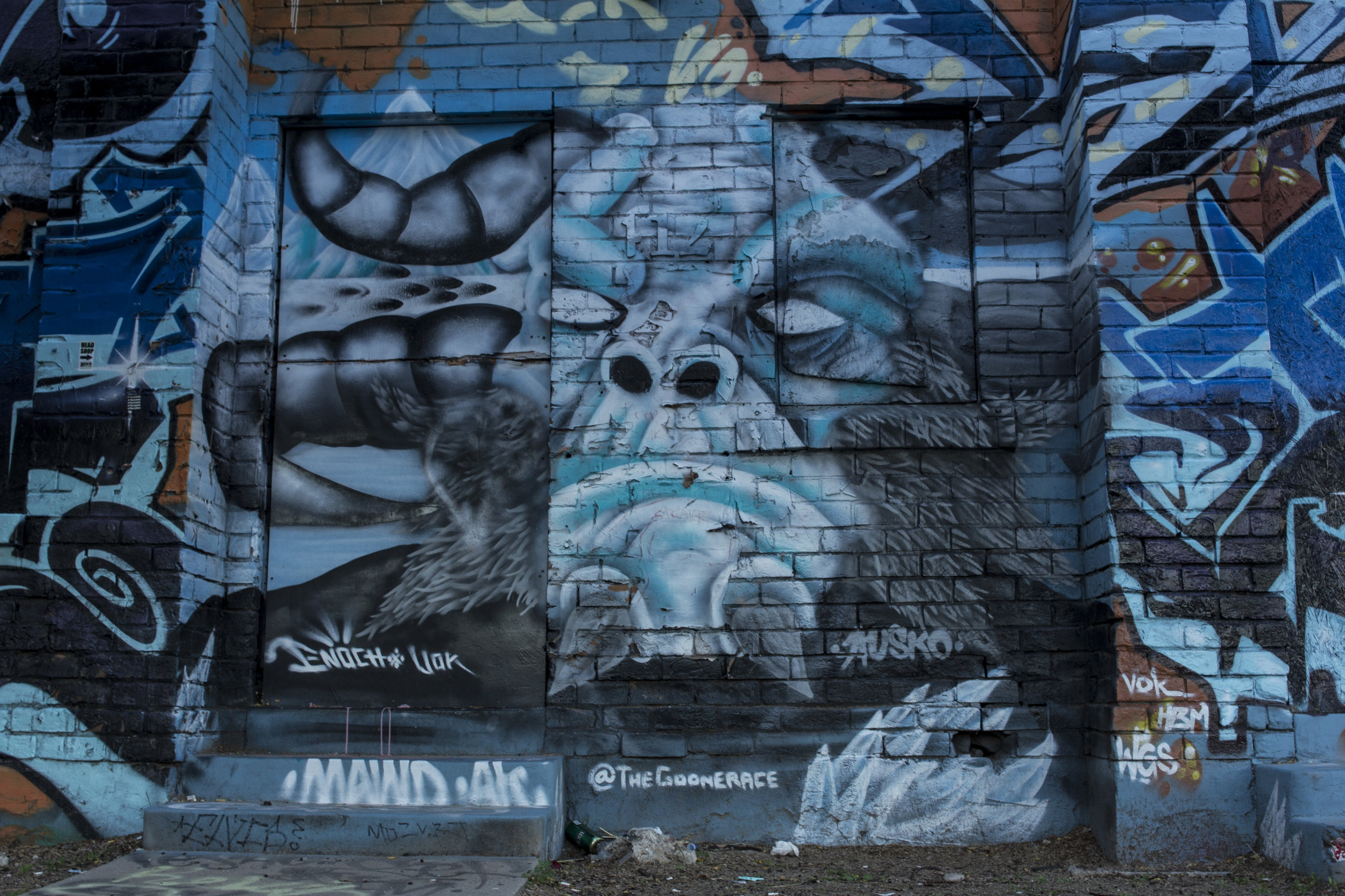 The electric blue two-story "graffiti altar" behind Bliss, mural by @TheGoonERACE. Photo by Brandon Salaz.