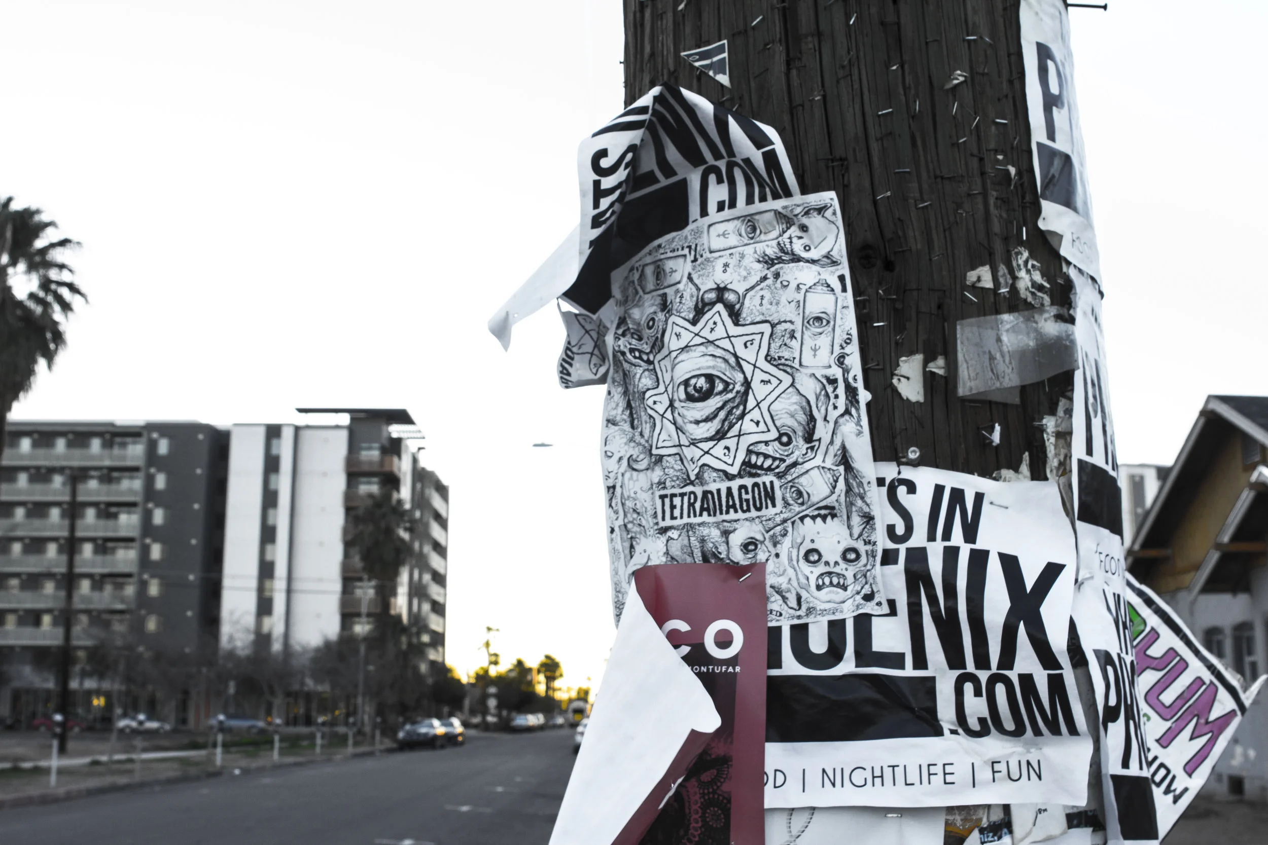 Hanging fliers on the light post on Roosevelt Row. Photo by Brandon Salaz. 