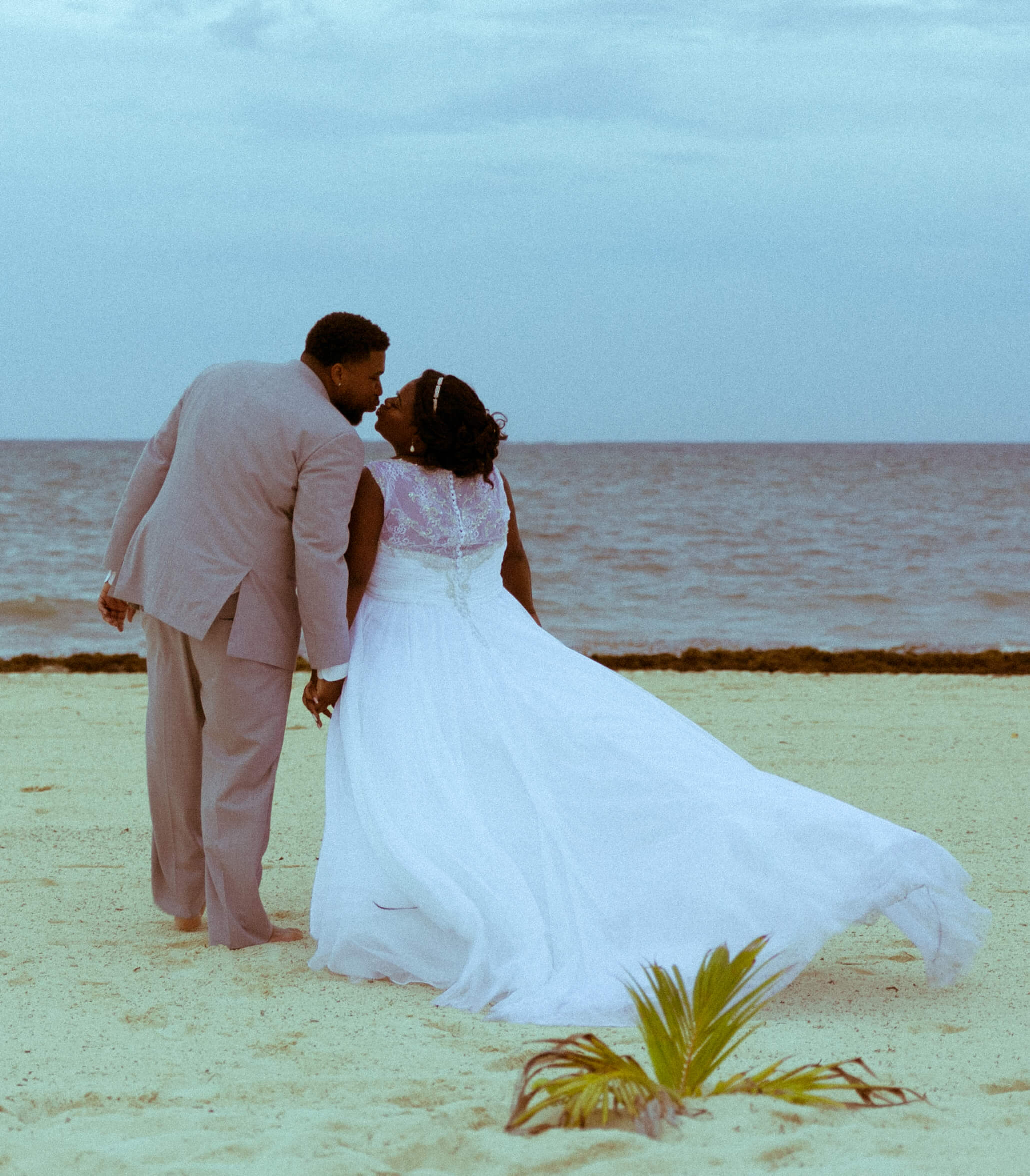 tressa-how-to-plan-a-destination-wedding-in-cancun-mexico-moon-palace-resort-black-destination-bride-destiland-desti-guide-to-destination-weddings-beach-wedding-kiss.jpg