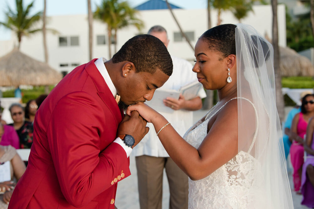 laura-how-to-plan-a-destination-wedding-in-oranjestad-aruba-hilton-aruba-resort-black-destination-bride-desti-tv-desti-guide-to-destination-weddings-2020-ring-kiss.jpg