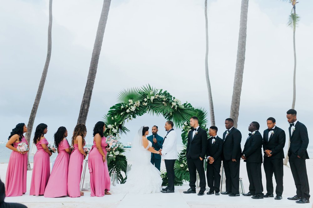 destibride-nicole-how-to-plan-a-destination-wedding-in-punta-cana-dominican-republic-jellyfish-restaurant-black-destination-bride-desti-tv-desti-guide-to-destination-weddings-2021-desti-couple-ceremony-with-bridal-party-circle-huppa.jpg
