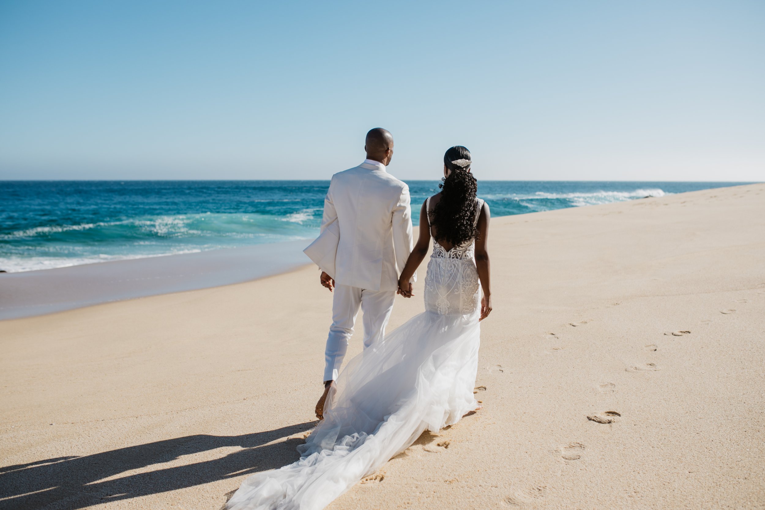 destibride-shar-how-to-plan-a-destination-wedding-in-cabo-san-lucas-mexico-villa-la-roca-black-destination-bride-desti-tv-desti-guide-to-destination-weddings-2022-beach-couple-back.jpg