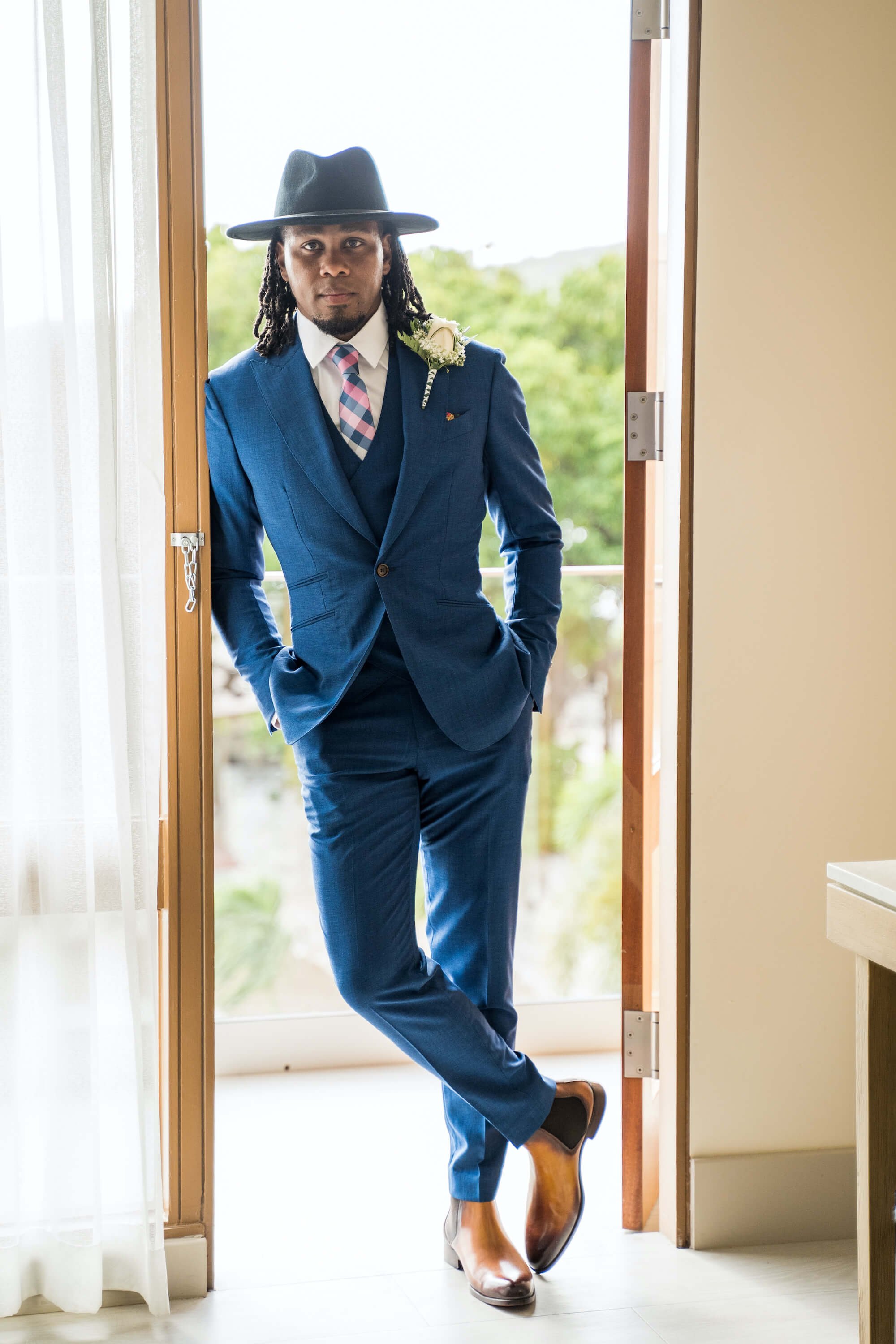 brittany-how-to-plan-a-destination-wedding-in-willemstad-curacao-dreams-curacao-resort-review-natural-hair-groom-locs-hat-blue-tuxedo-suit-black-destination-bride-desti-tv-desti-guide-to-destination-weddings-1-2022.jpg