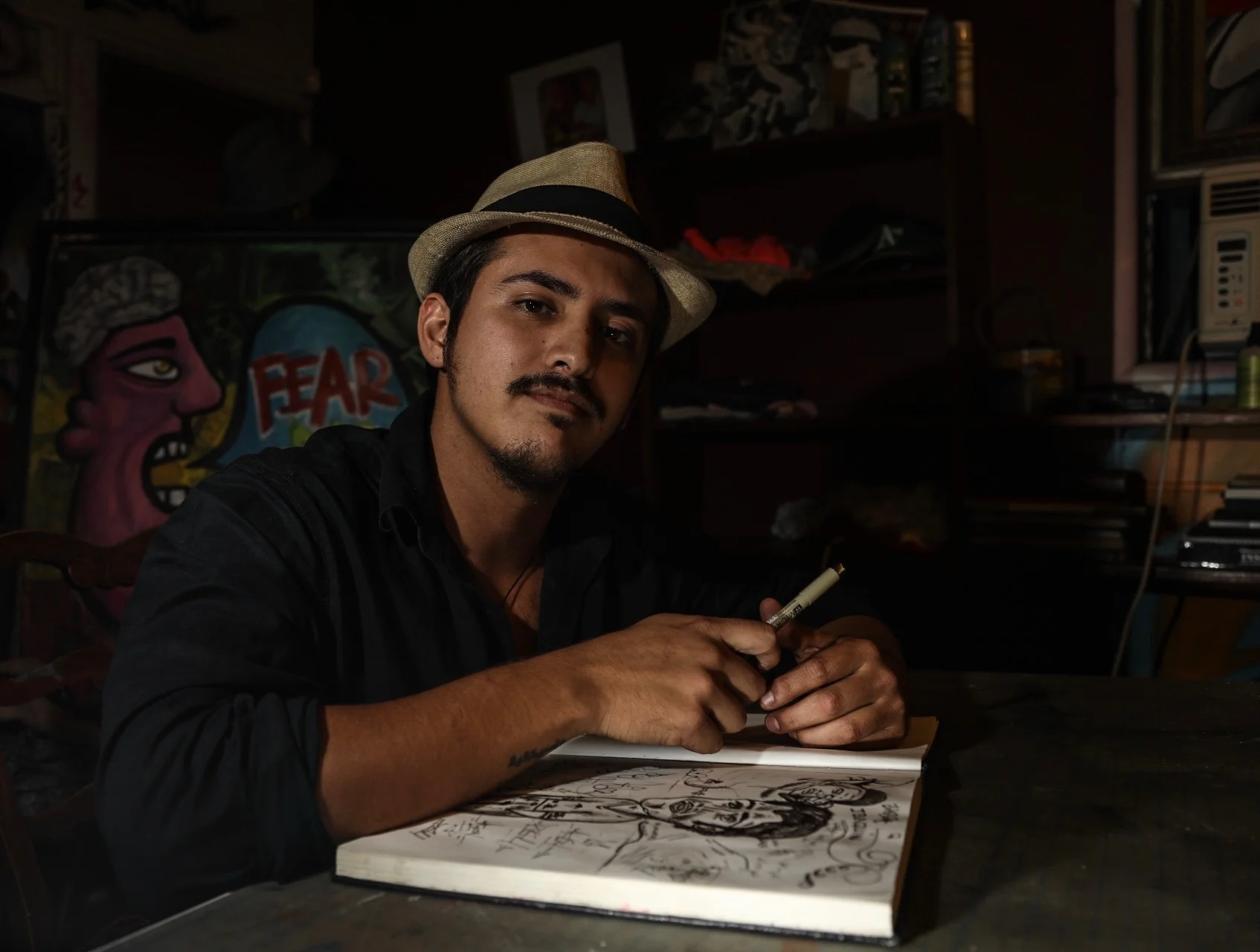  Alejandro Chavez sits at his drafting table and conveys his thoughts and feelings through art in his pasadena area art studio on Oct. 18, 2016. 
