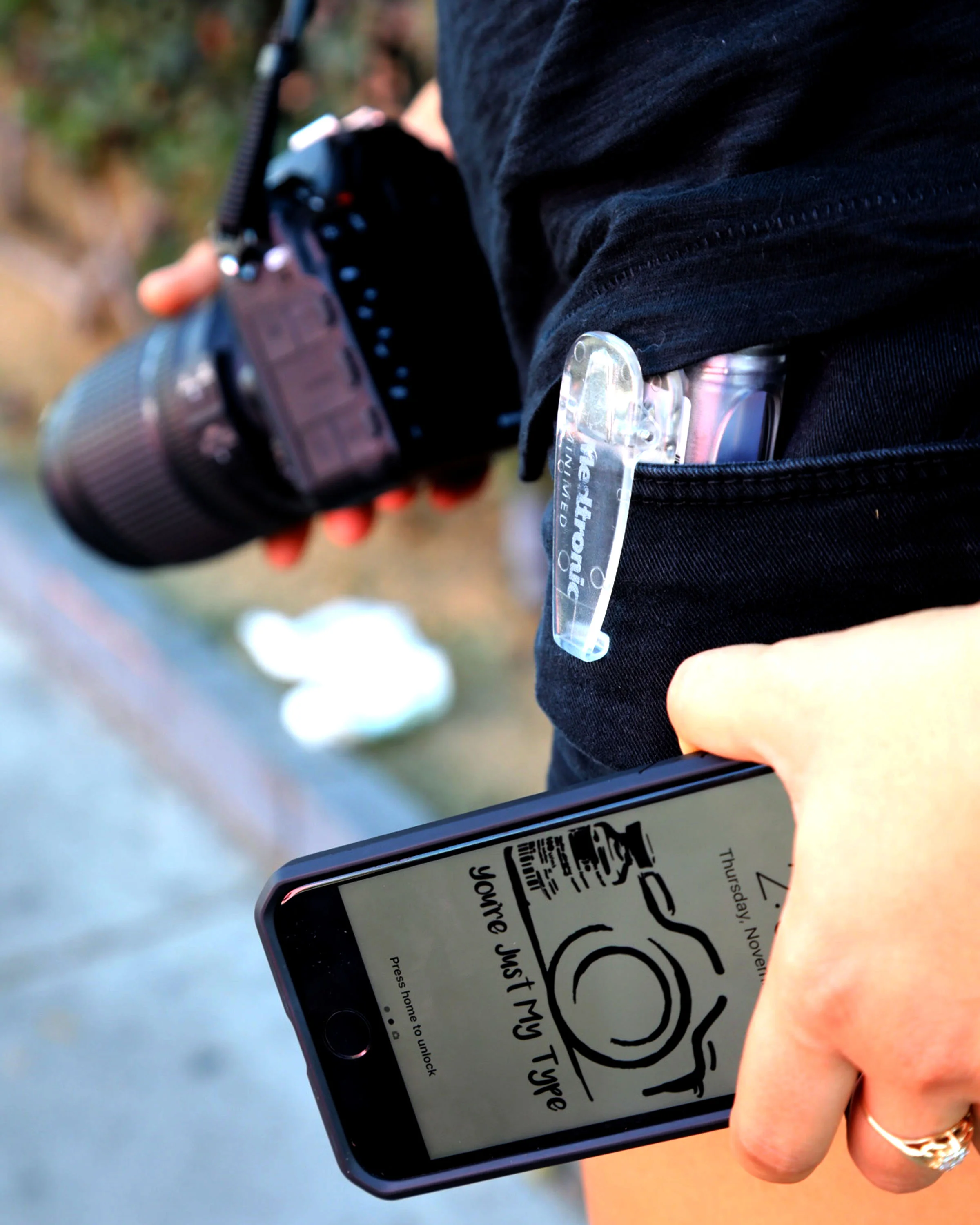 Laura Pavlakovich, holds her phone displaying the logo of her nonprofit “You’re Just My Type” with her insulin pump and camera in the background while on a shoot in Los Angeles on Nov. 3, 2016.