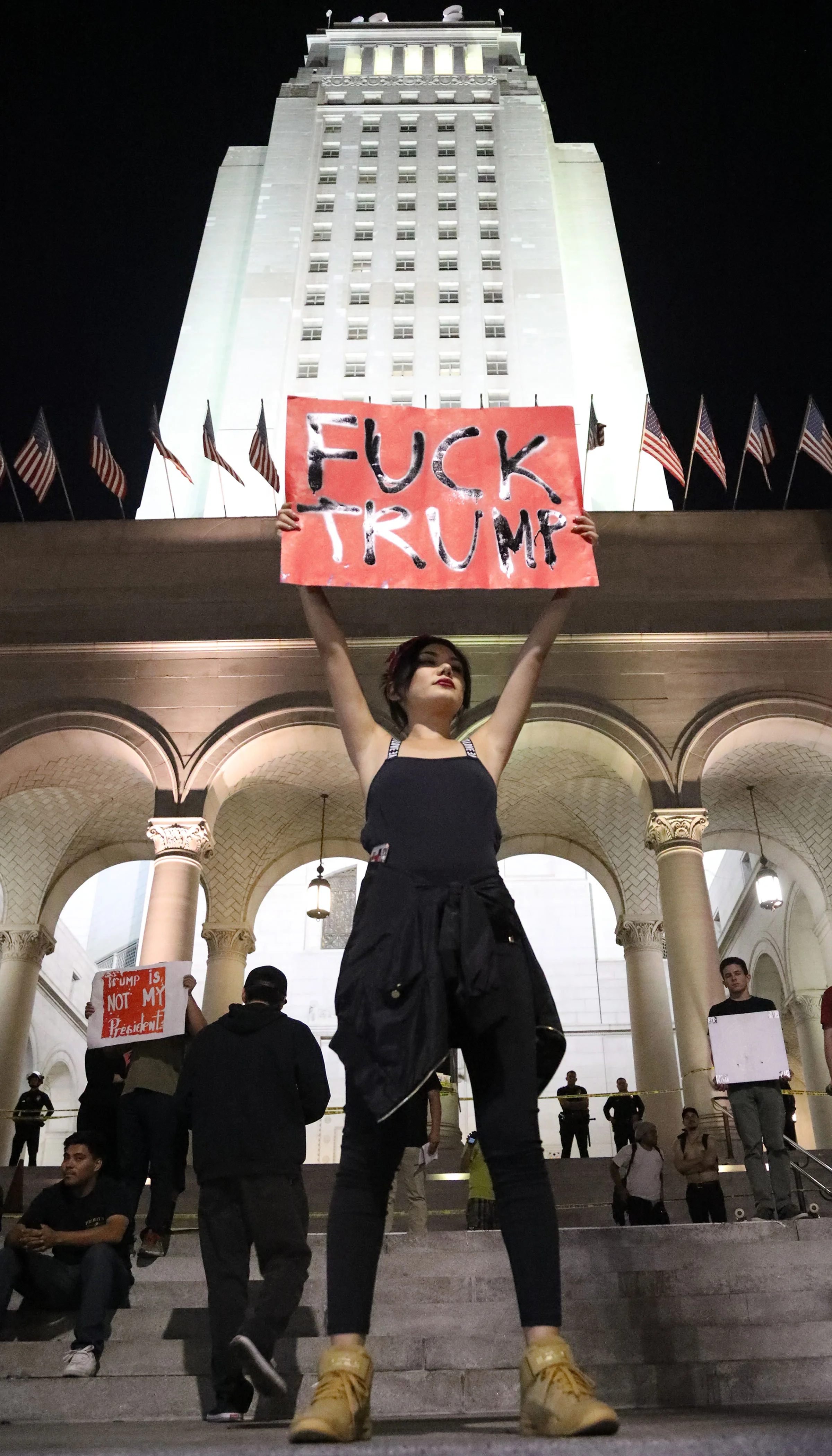Alejandra Medina holds up her “Fuck Trump” sign at the protest held in response to the outcome of the presidential election in Downtown Los Angeles on Nov. 9, 2016