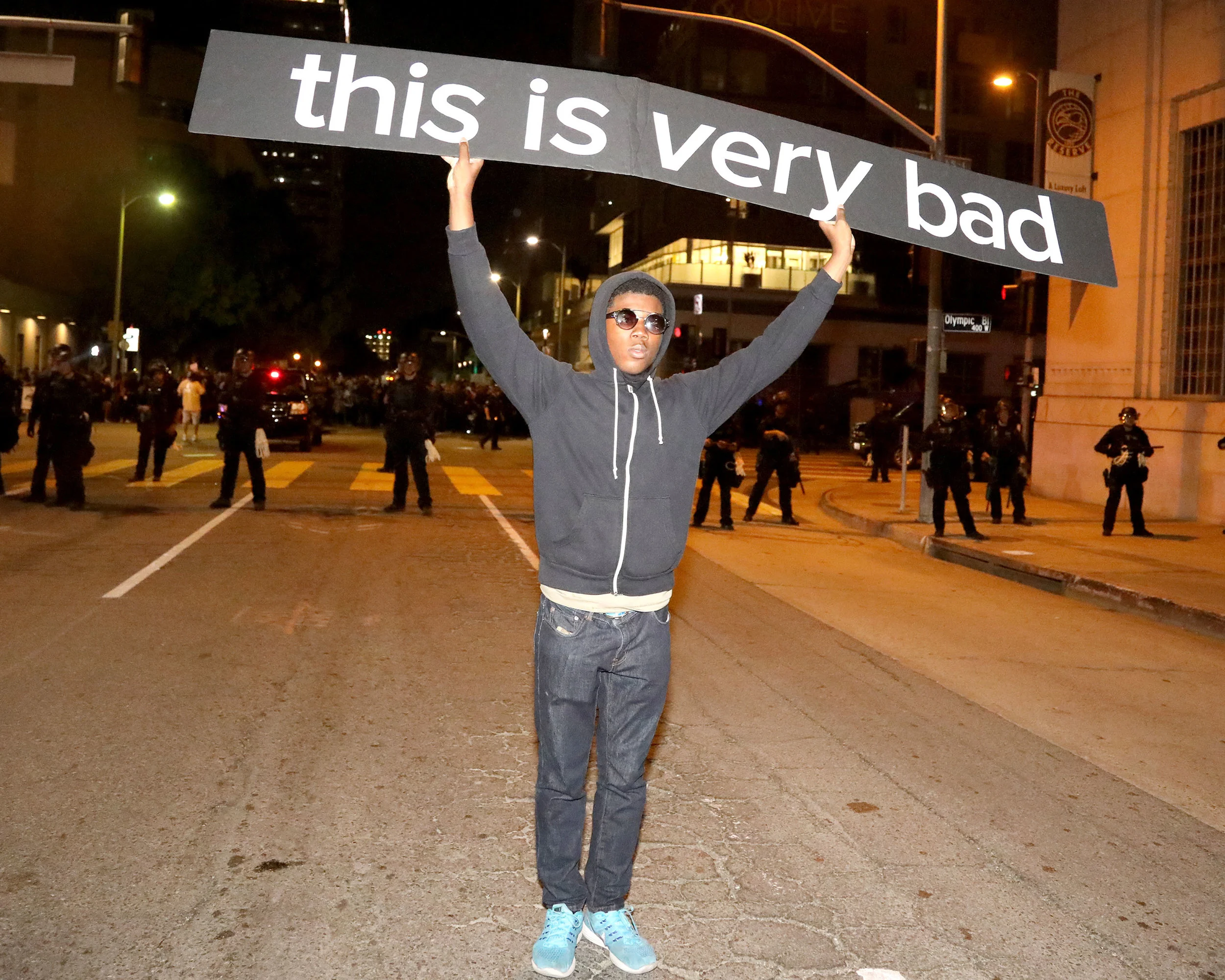 A young protester holds up his sign in front of a line of L.A.P.D. officers in riot gear at the protest held in response to the outcome of the presidential election in Downtown Los Angeles on Nov. 10, 2016