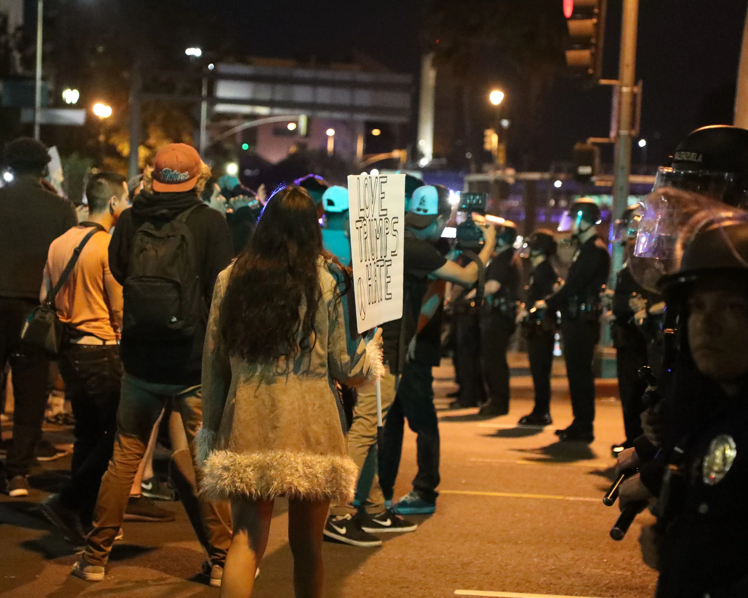 Protesters march in front of a barrier set by L.A.P.D. Officers at the protest held in response to the outcome of the presidential election in Downtown Los Angeles on Nov. 9, 2016