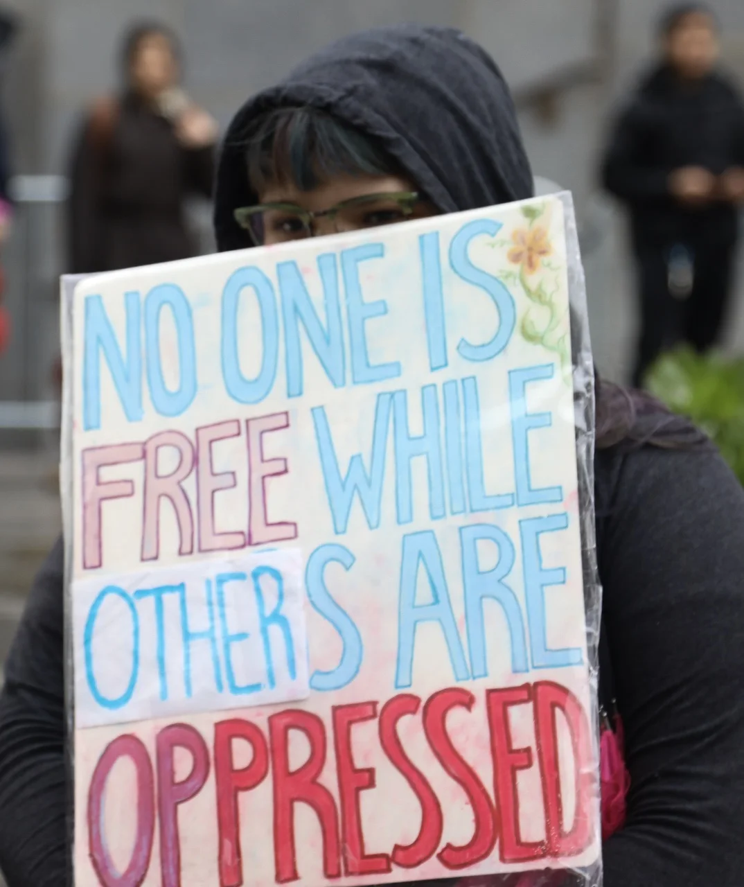 A protestor holds her sign during the United Against Hate march on Friday Jan. 20, 2017