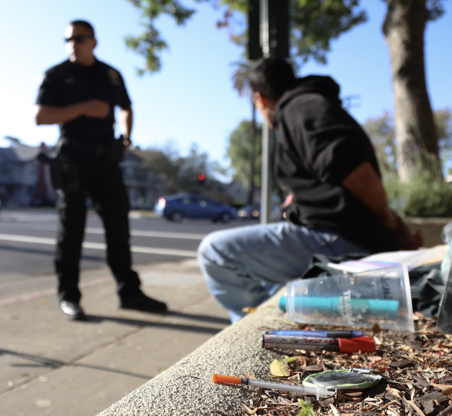 Michael Watkins/ Courier Officer Chris Perez of the South Pasadena Police Department calls for another officer to transport the suspect after a search turned up vandalisim paraphernalia as well as a needle and the bottom of a can used to shoot up drugs on April 20, 2017.