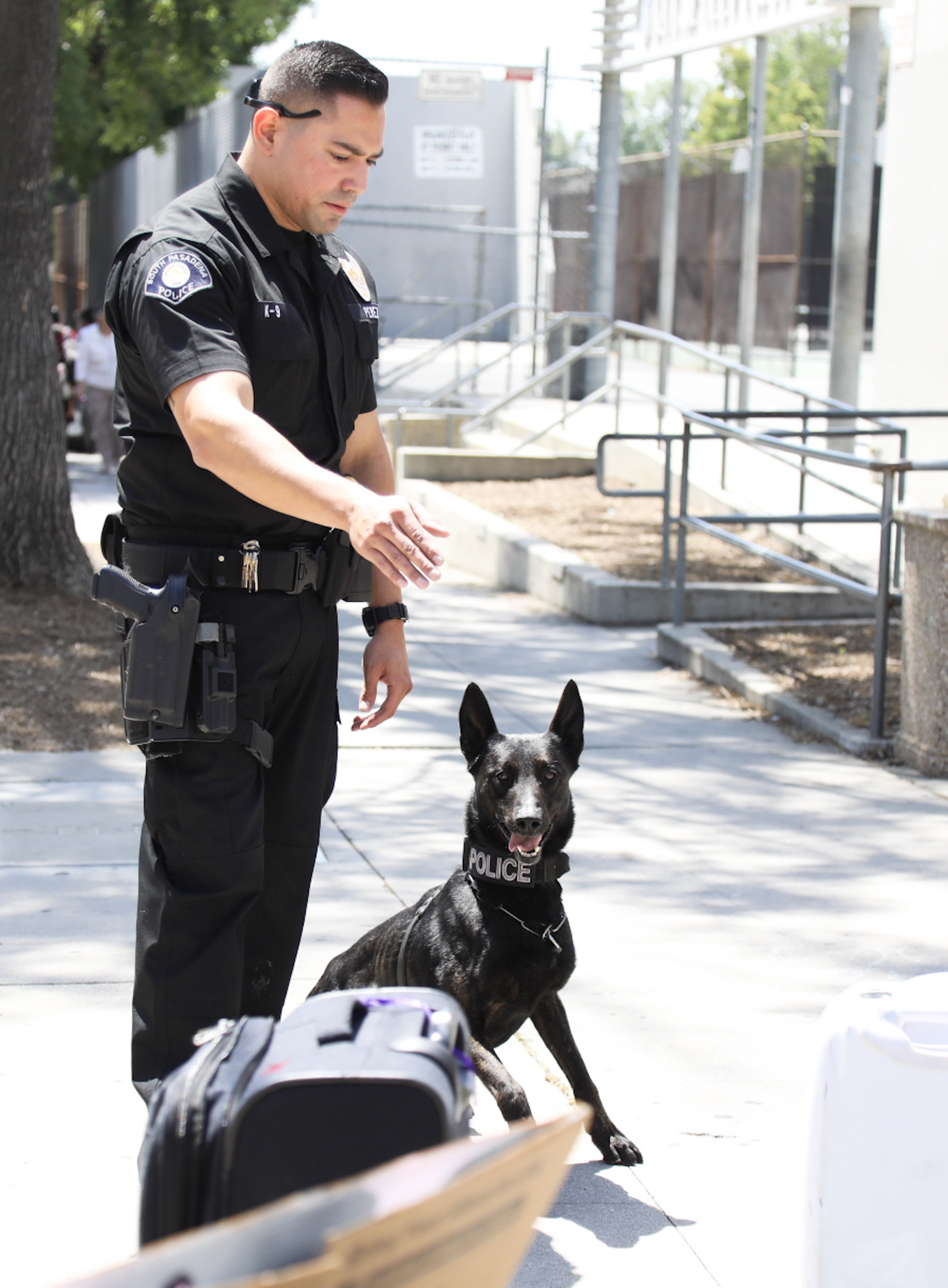 Michael Watkins/ Courier Officer Chris Perez of the South Pasadena Police Department instructs his Partner Barry the K-9 unit to search the luggage of kids from South Pasadena High School before they leave on a field trip on April 20, 2017.