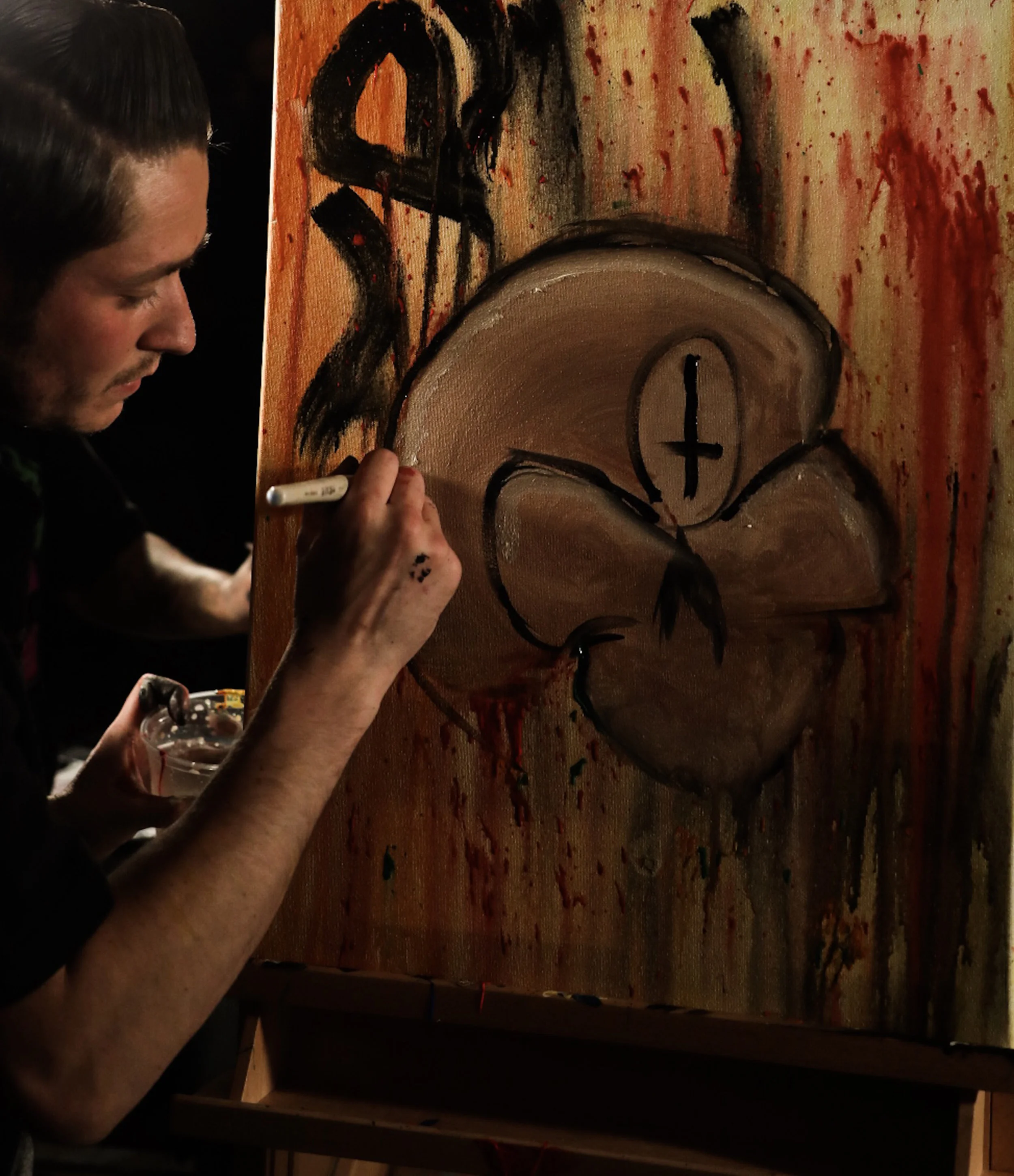 Michael Watkins/ Courier Wildcard entry Spaz12 works on his painting during Art Battle LA at Boomtown Brewery in Los Angeles on May 9, 2017.