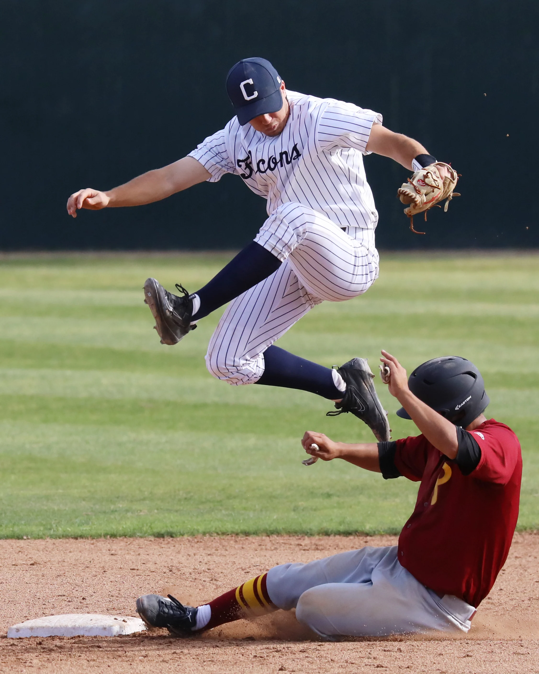 Michael Watkins/ Courier Andres Kim (7) of PCC slides into second under a leaping Derrick Edwards (37) to break up a double play and put runners on first and second during the Lancers 6-5 win on the road at Cerritos College on march 14, 2017.