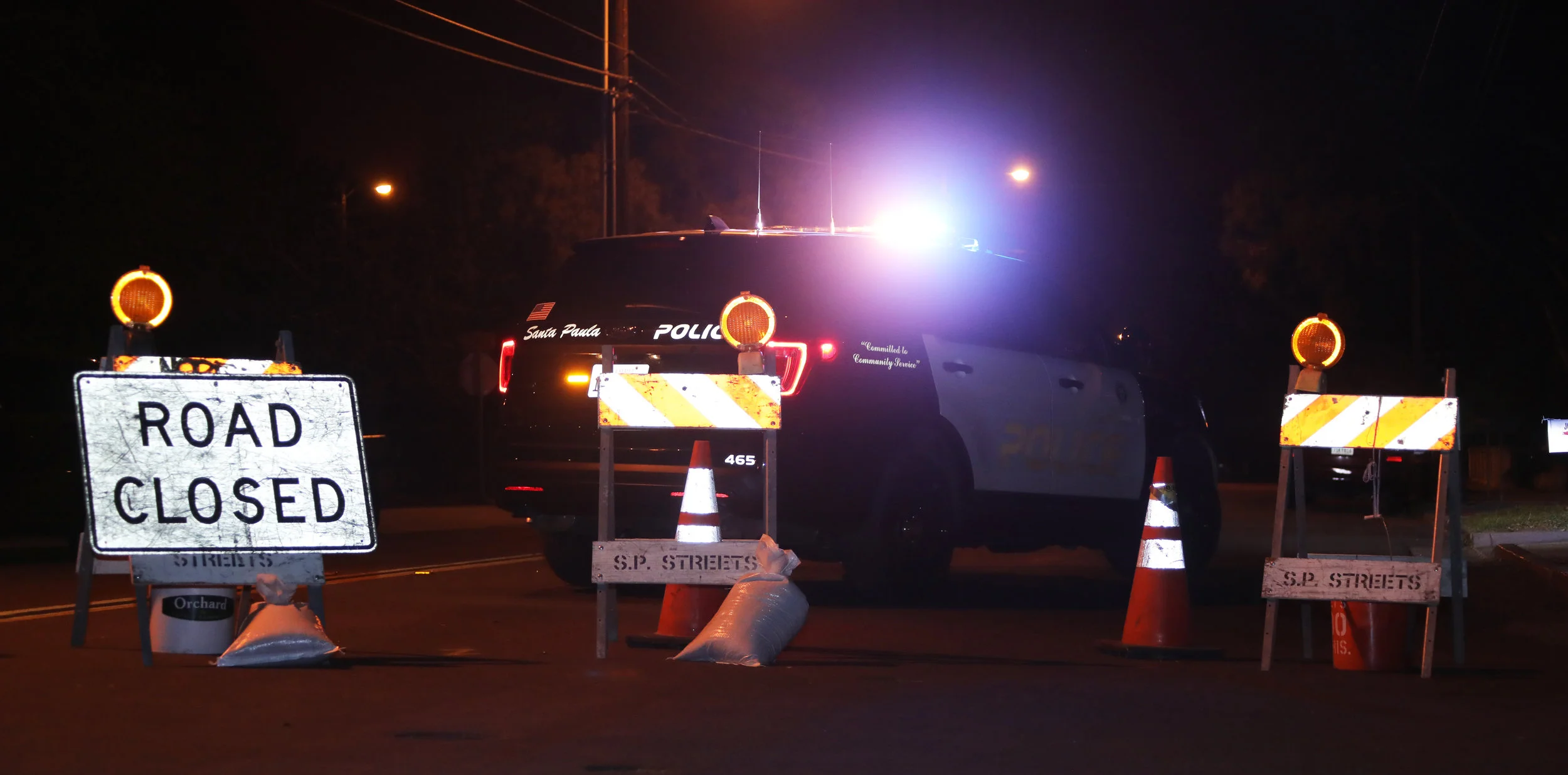Michael Watkins/ Courier A Sata Paula Police car blocks the road leaing to the fire during the first night of the Thomas Fire in Santa Paula, Calif. on December 4th, 2017. 
