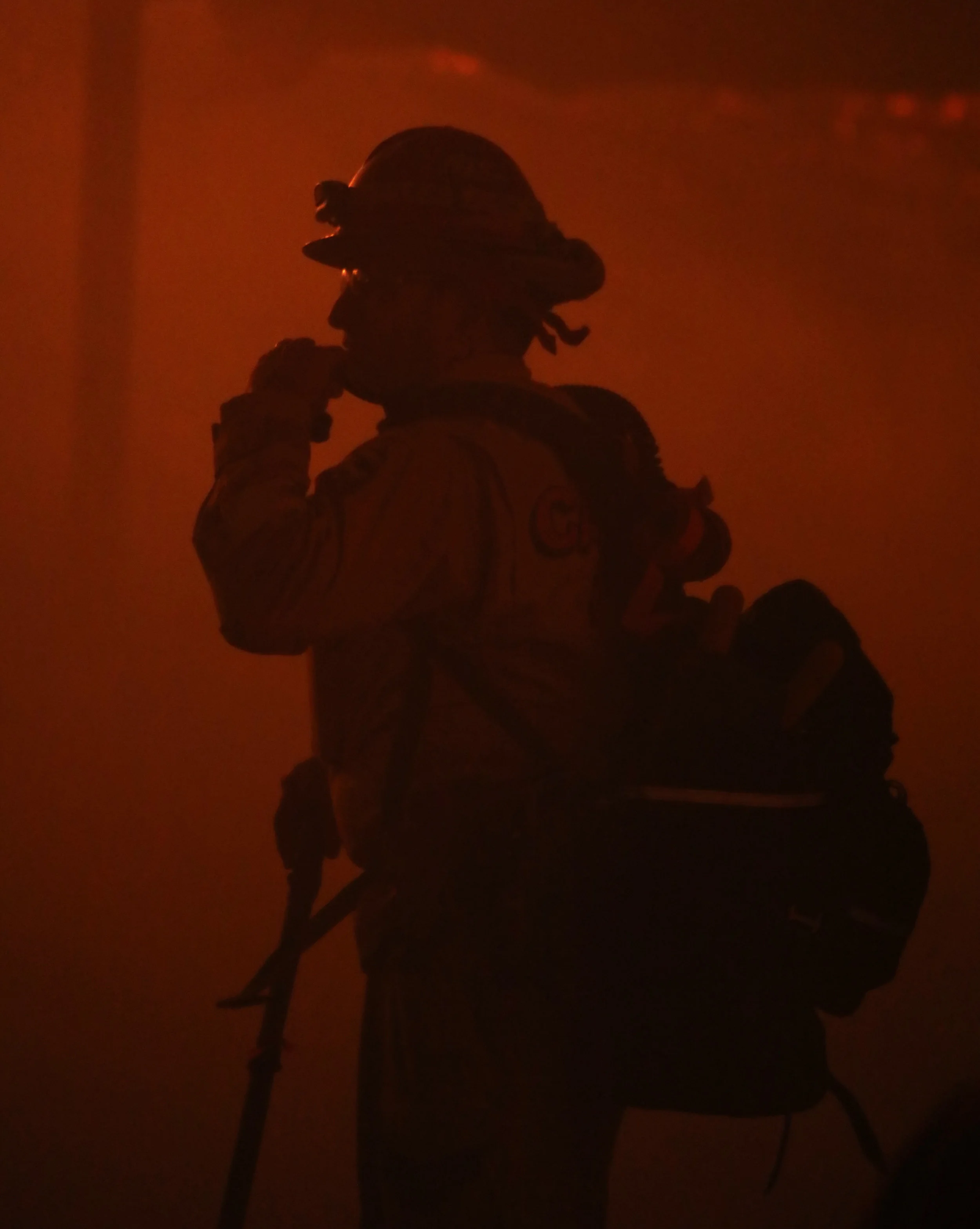 Michael Watkins/ Courier A Fire Fighters from the Ventura County Fire Department takes a break to drink some water during the Thomas Fire in Santa Paula, Calif. in the early morning hours on tuesday December 5th, 2017.