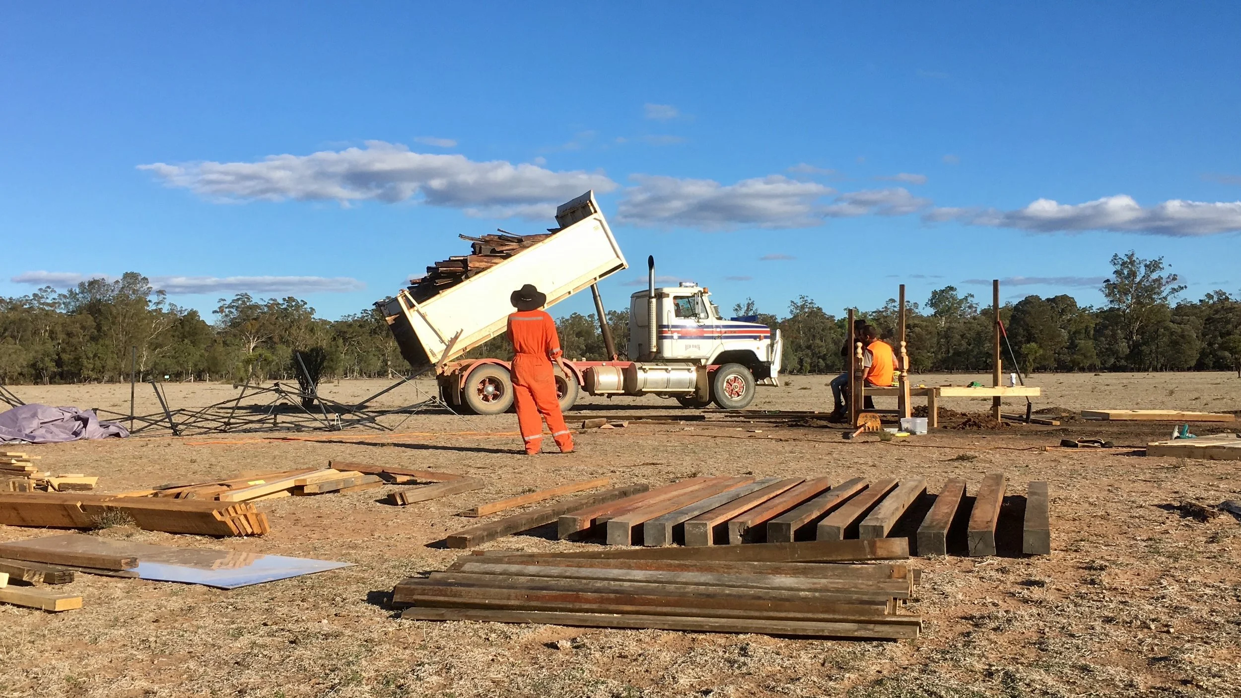 Jorja and James look on as local contractor Red Rock makes the first delivery of Ironbark flitches from Ken Reilly’s hardwood mill.
