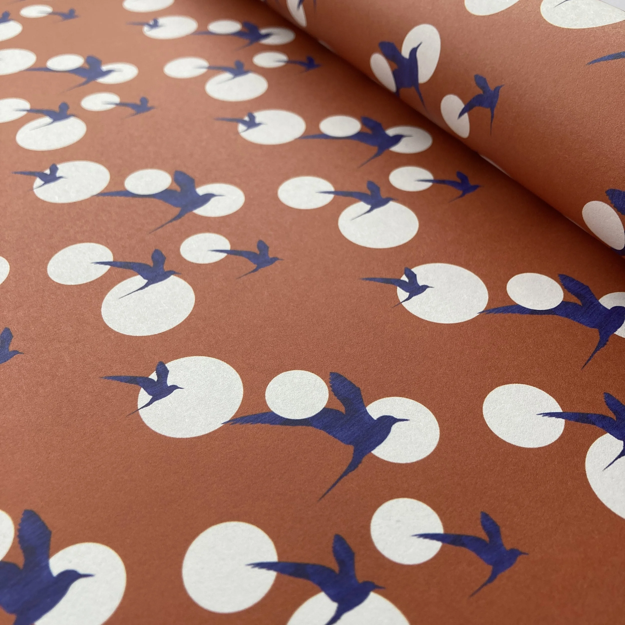 Arctic Tern Gift Wrap with blue terns, white dots and a rusty orange background