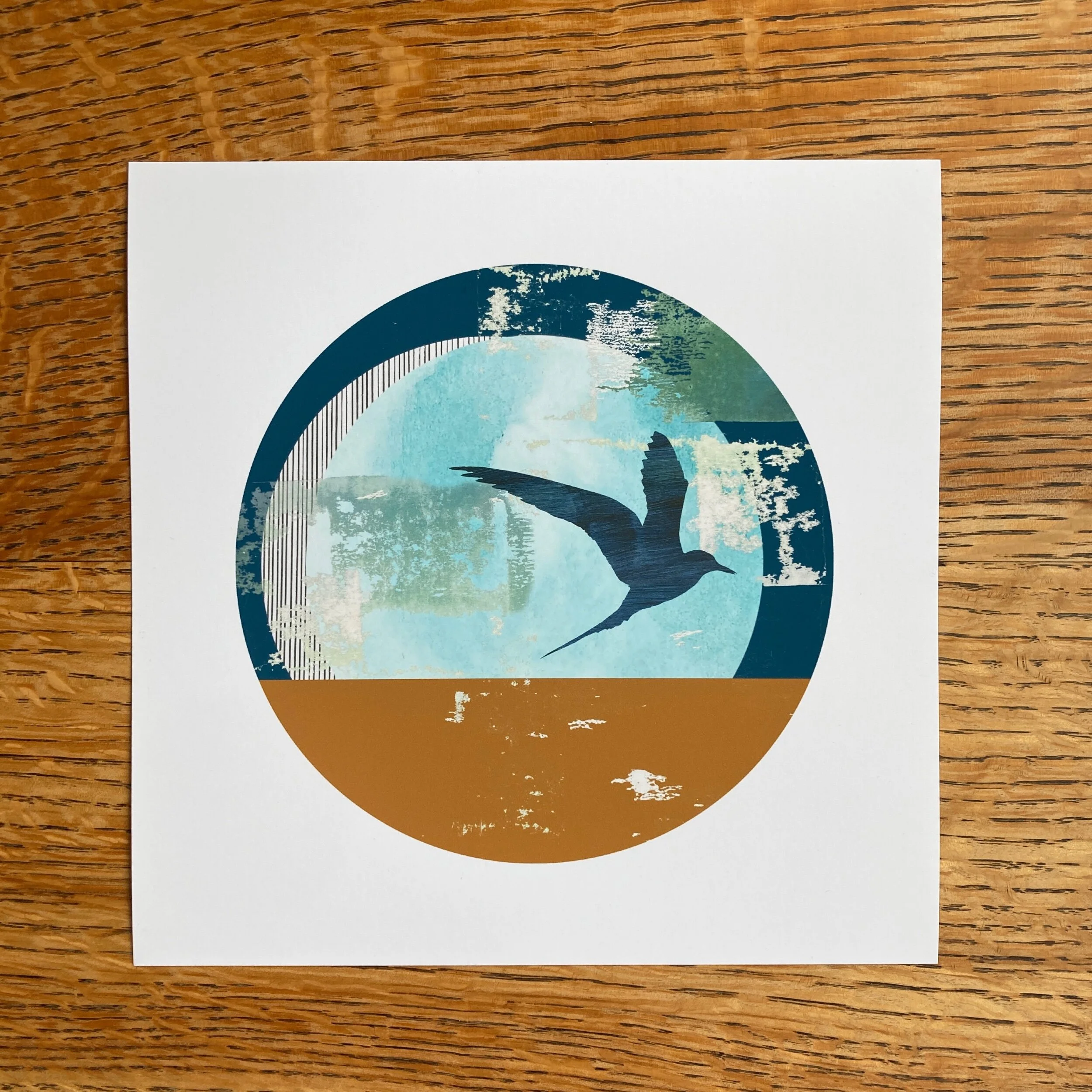 Let's Tern the Tide, an 8x8" mini fine art print of an Arctic tern with abstract shapes in blues and ochre. The design has a circular aperture with white border