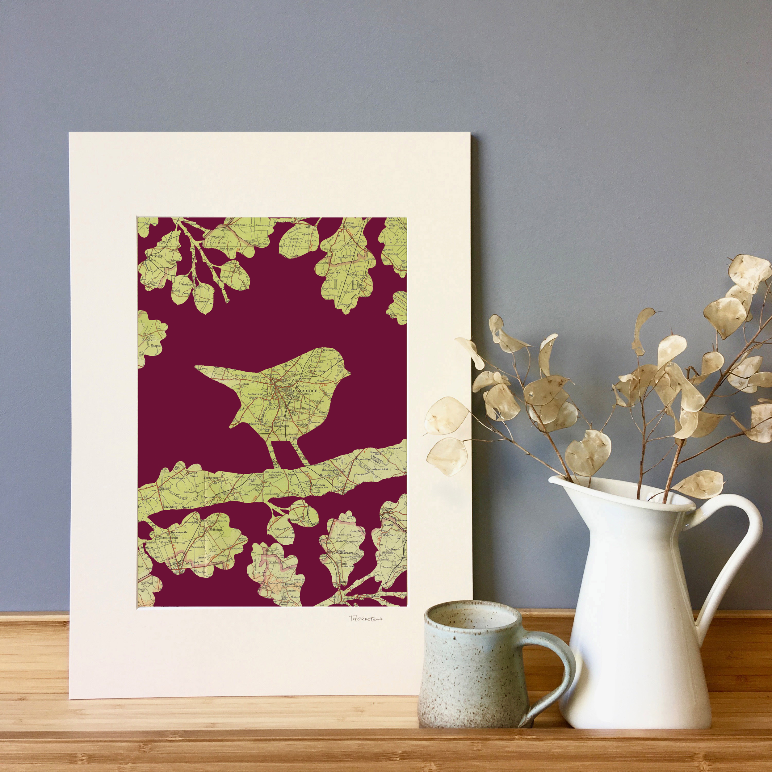 An A3 fine art print of a Robin silhouette in an oak tree made from a vintage map. Can be personalised with any UK map and choice of colourways.