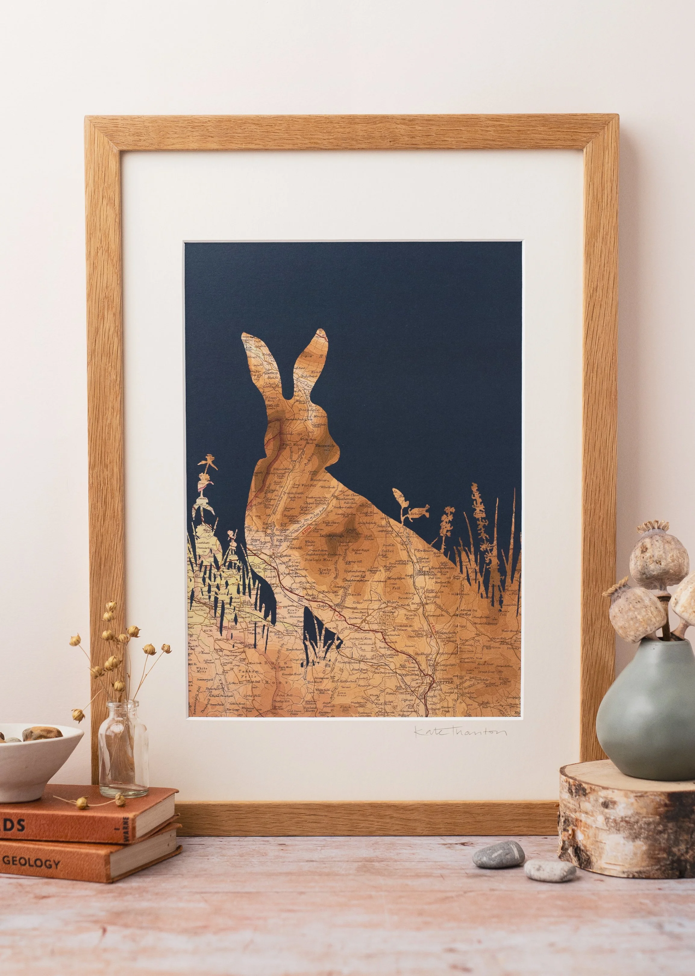 A bespoke map print of a wild Hare which can be customised with vintage maps and coloured backgrounds