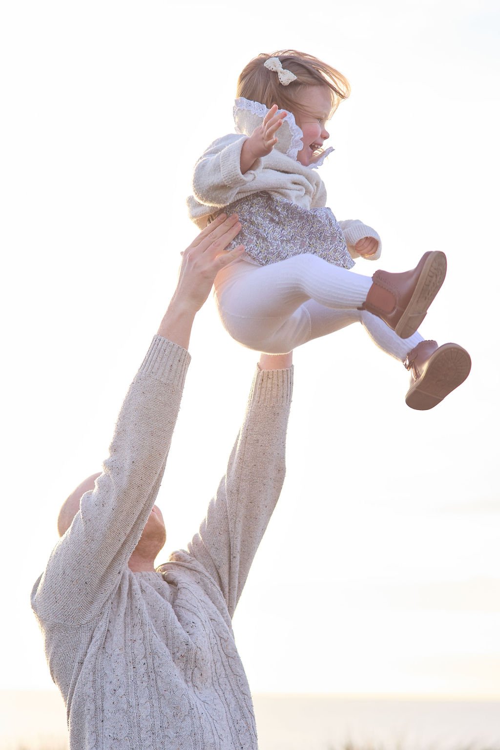 Toddler and dad swinging in the air