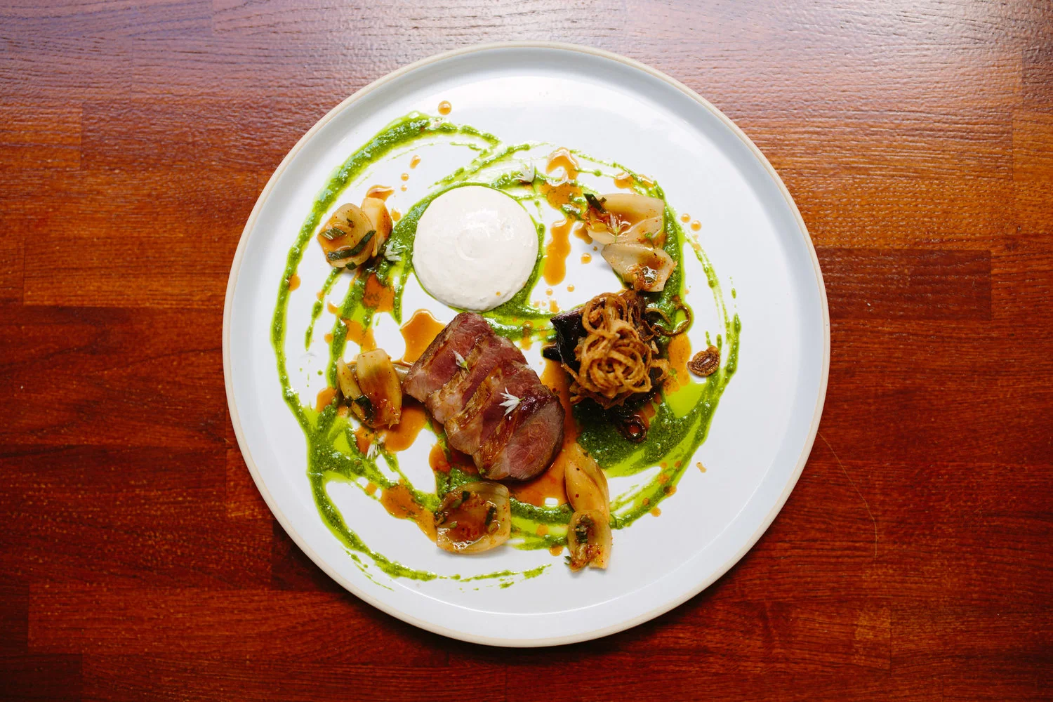 Roast haunch of Herdwick lamb, ewe's curd, wild garlic, crispy shallots