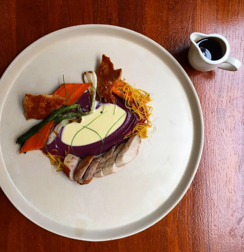Roast haunch of middle white pork, yogurt & garlic panna cotta, carrots, calçot onion