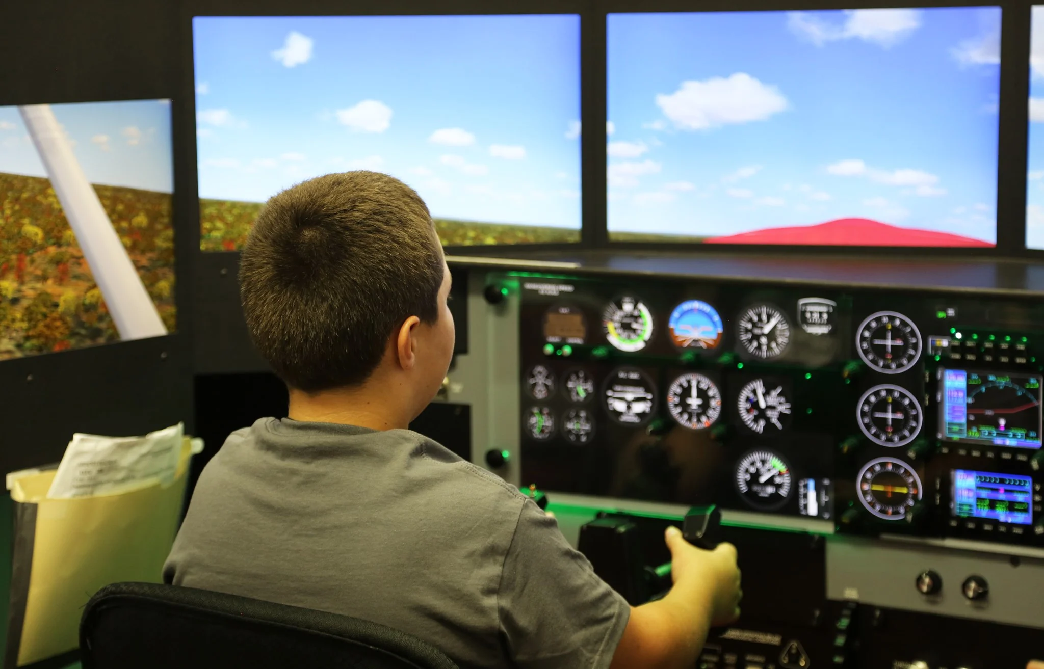 An Ozarka Aviation Camp participant practicing his flight skills in the simulator.